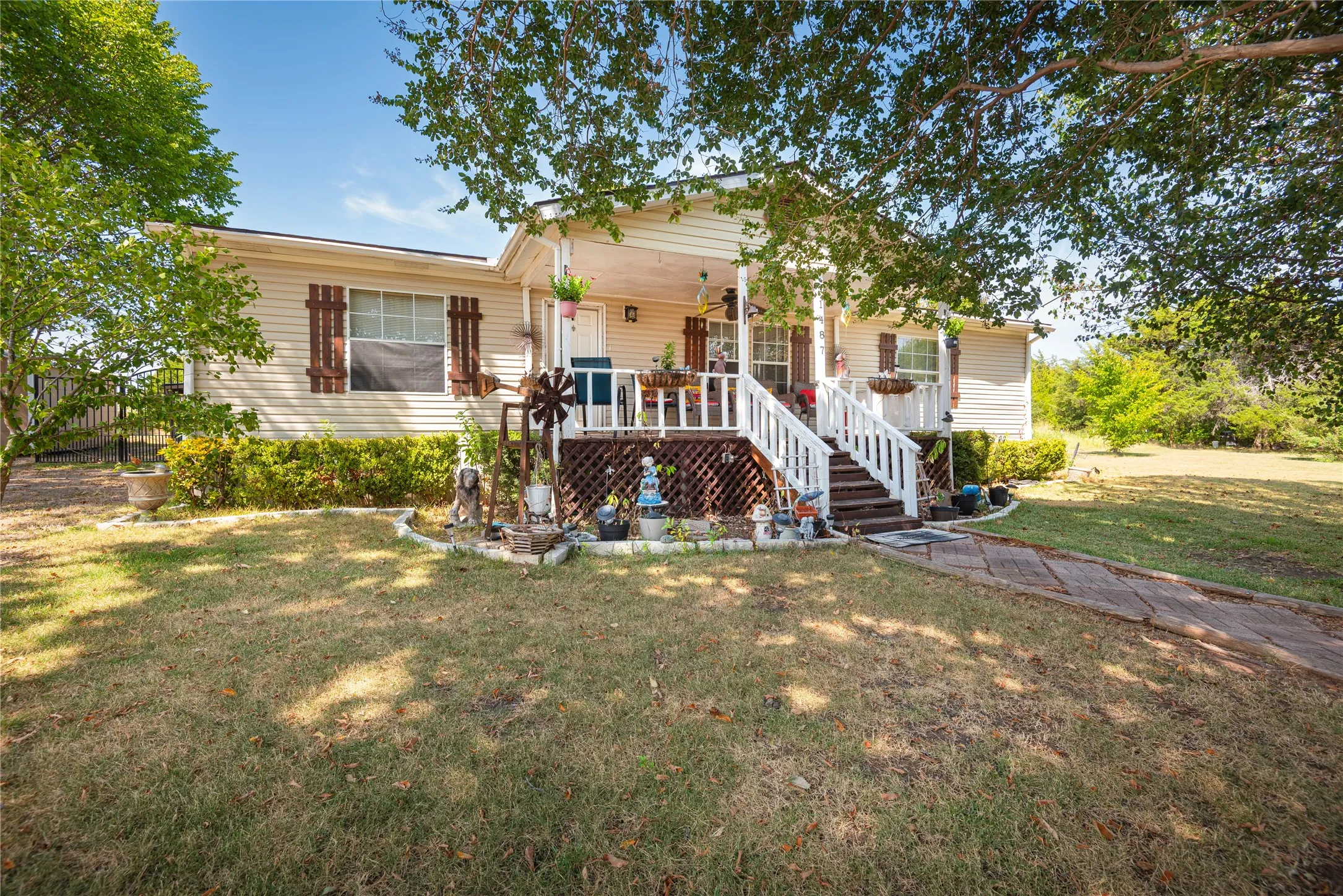 Front elevation with horizontal siding and decorative wooden shutters
