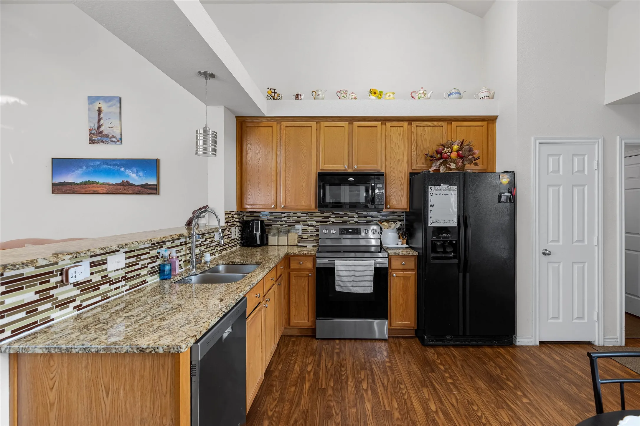 Open kitchen concept with spaces for bar stools, small breakfast table, pantry, and even room a small movable island.