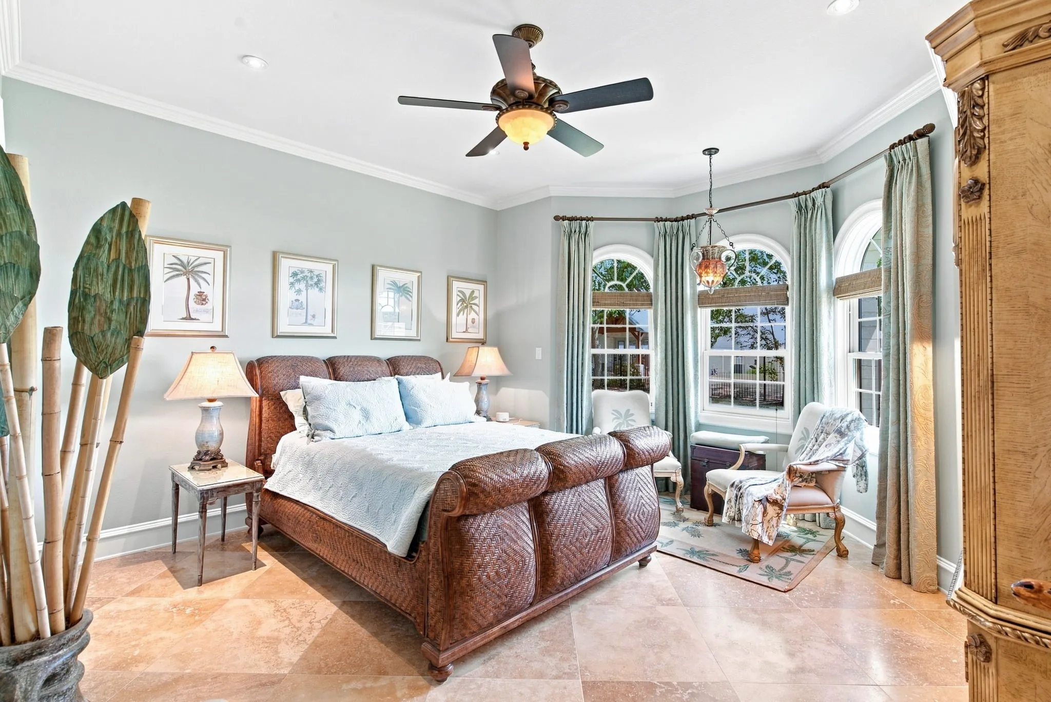 Tray ceiling with recessed lighting, ceiling fan, and crown molding
