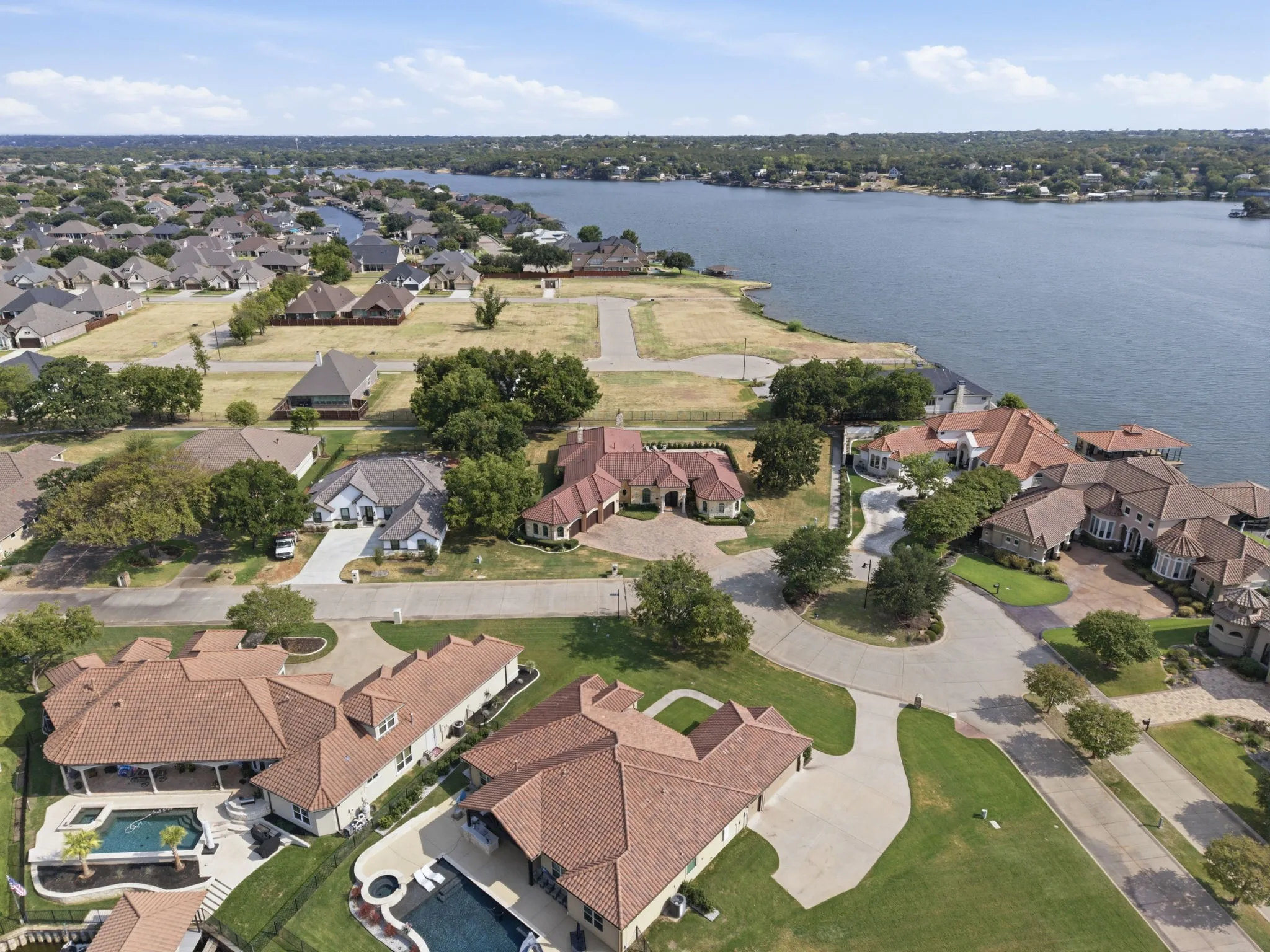 Waterfront property with private boat docks, mature trees, and a residential neighborhood setting