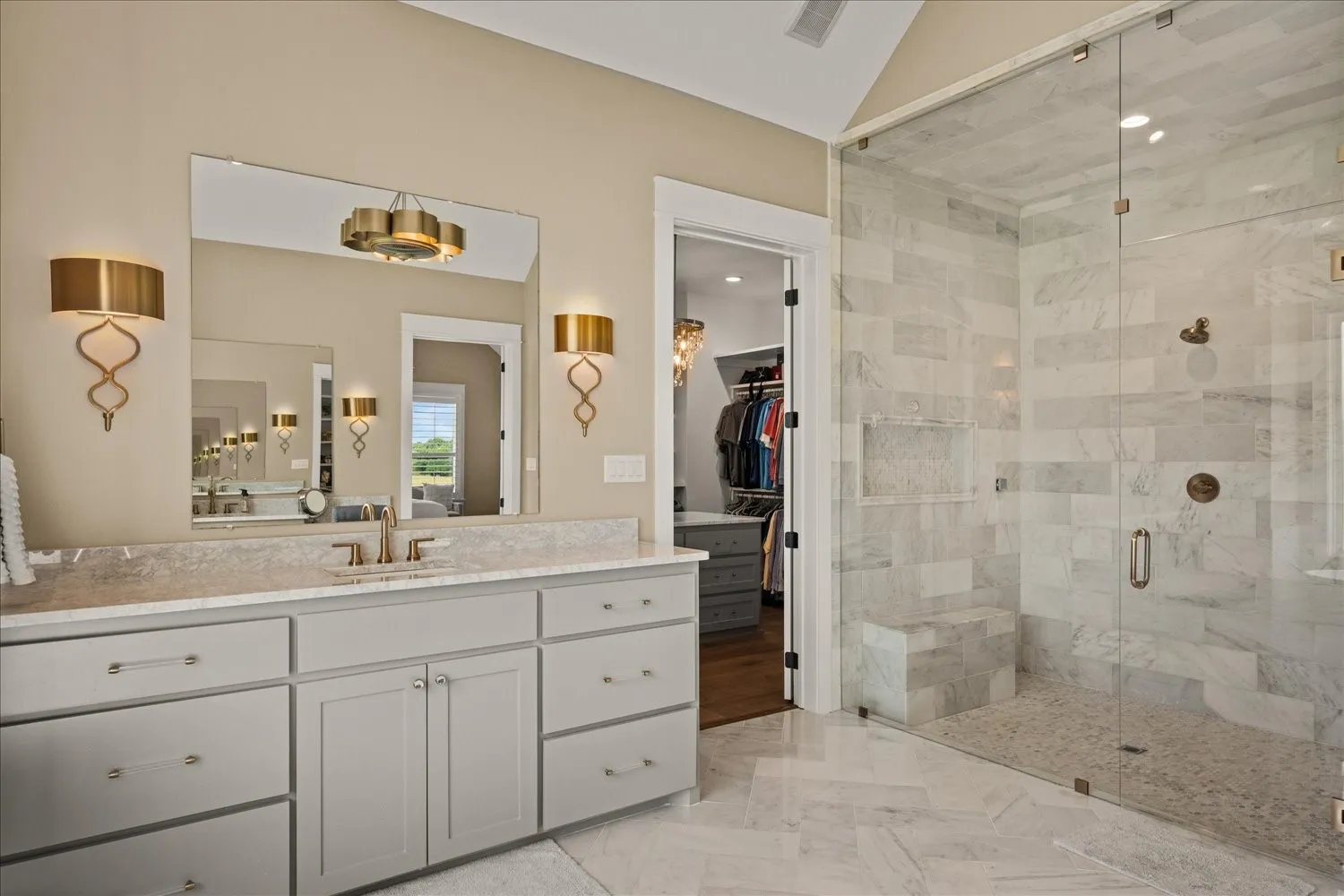 Dual vanity with gray cabinetry and stone countertop