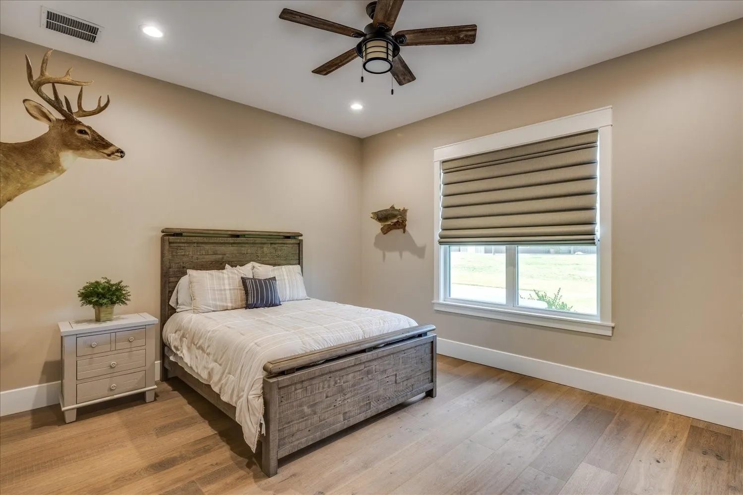 Wood-finish flooring, recessed lighting, and a ceiling fan with integrated lighting