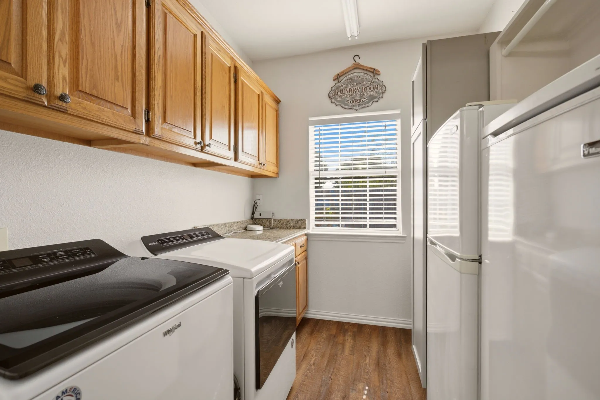 Large laundry room with plenty of cabinets and storage space