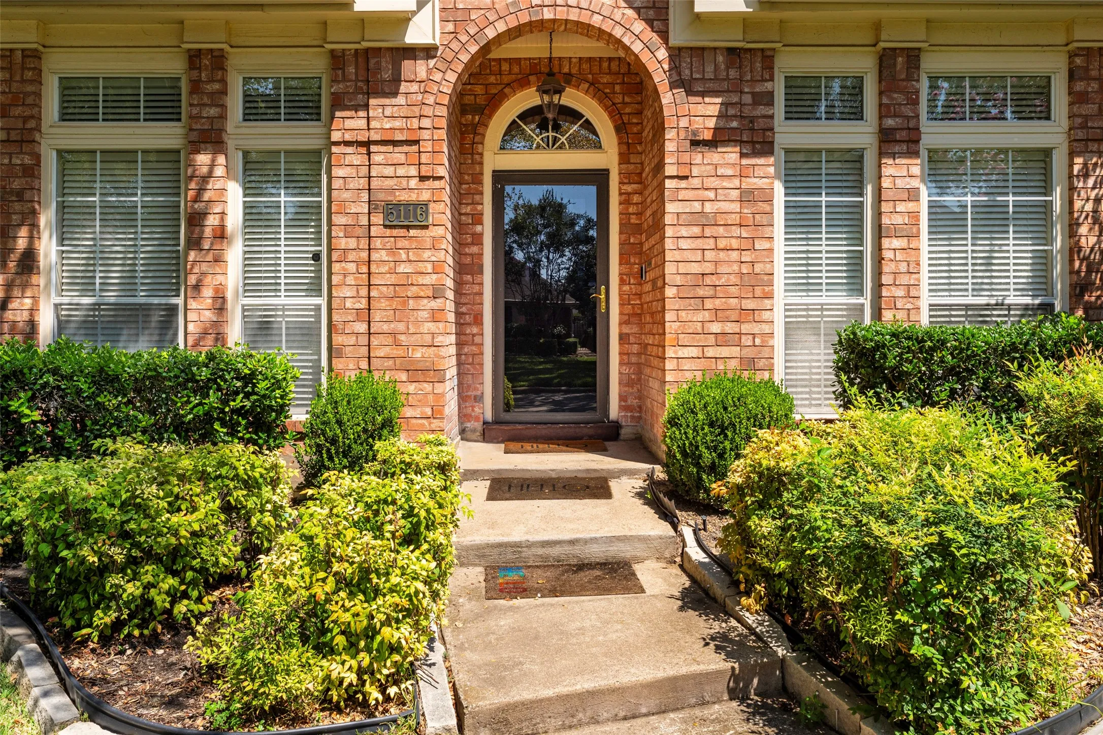 Brick exterior with arched entryway and transom window