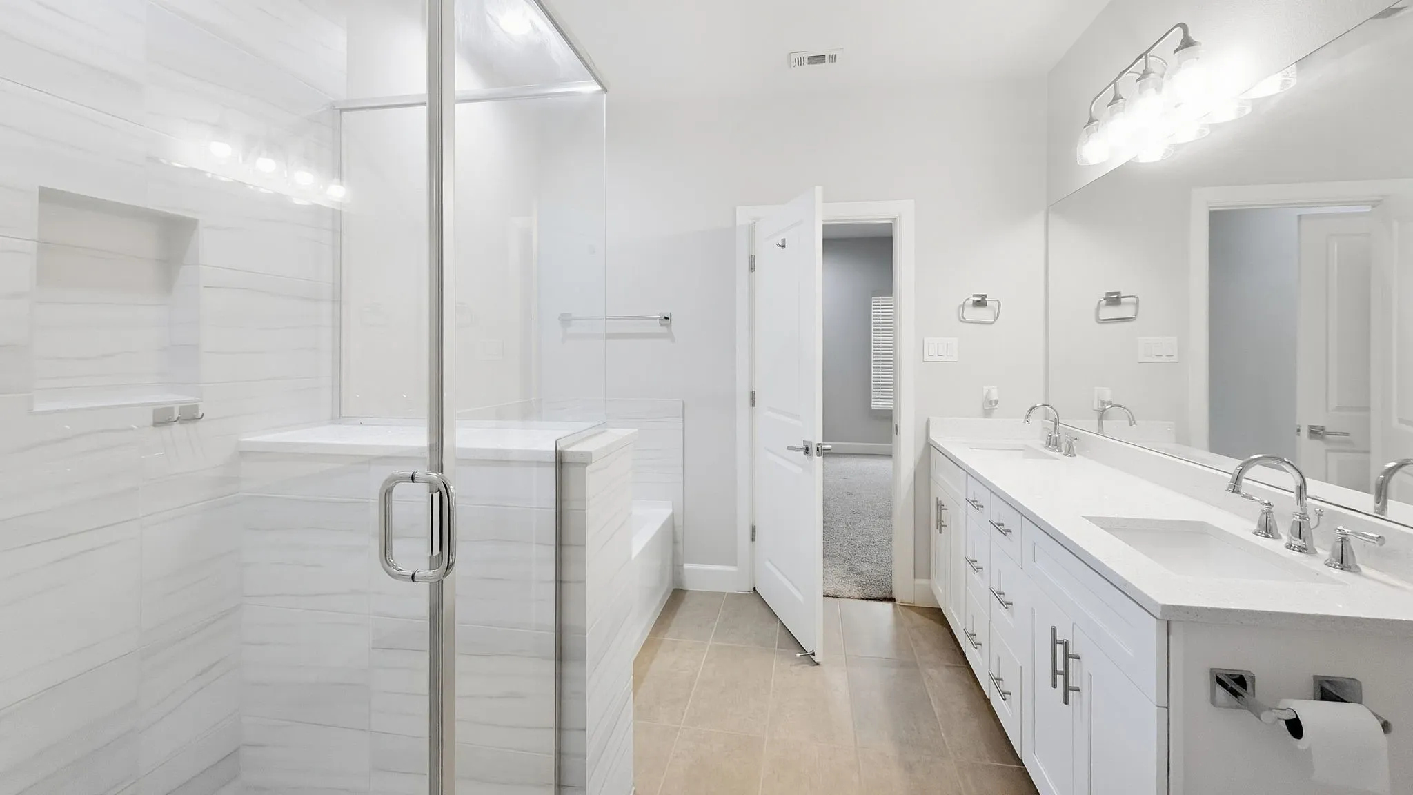 Glass-enclosed walk-in shower with integrated bench and niche