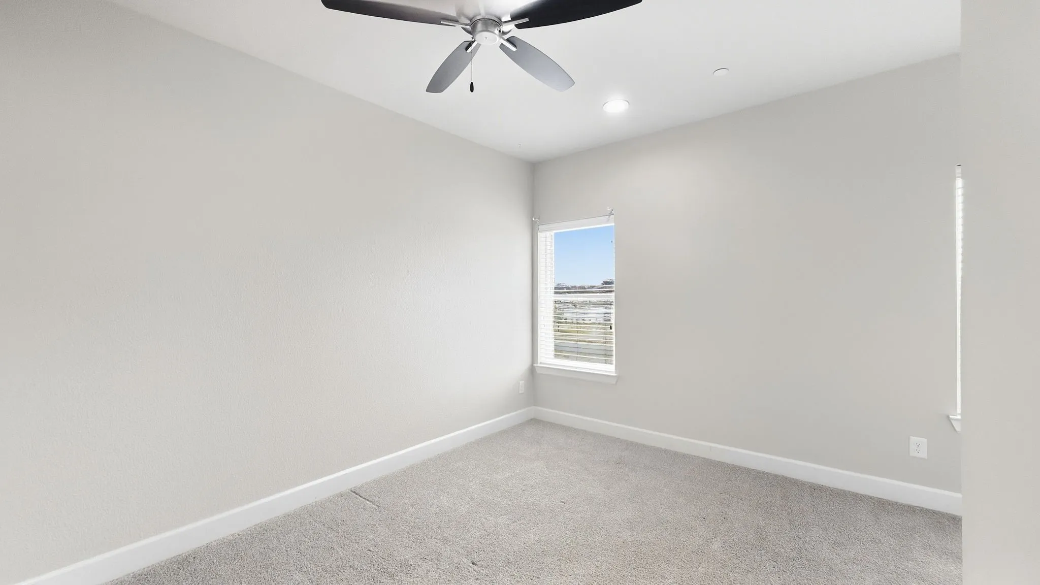 Neutral-toned walls complement the gray carpeting