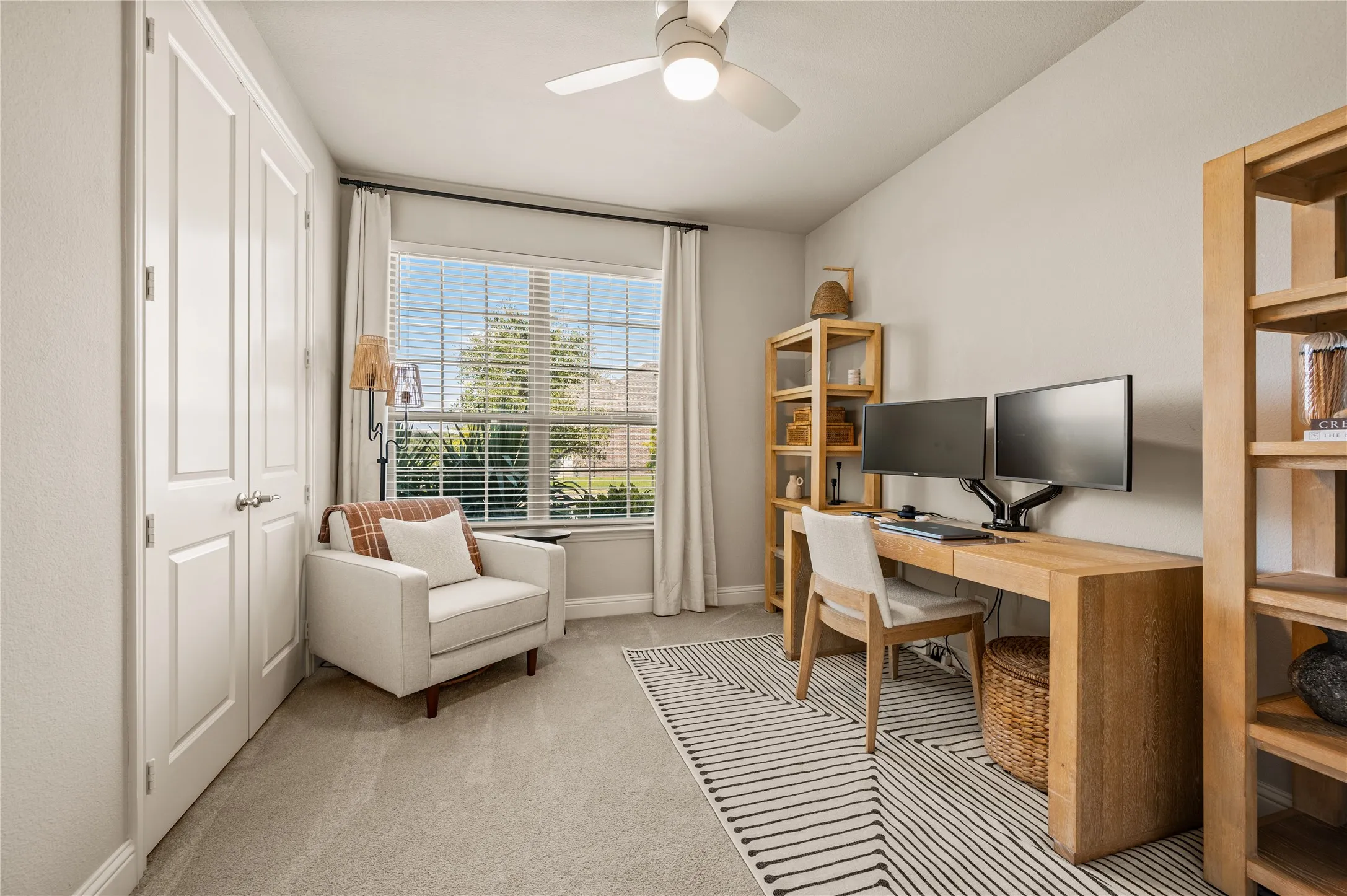 Recessed lighting, ceiling fan, white paneled doors, window with blinds, and neutral wall tones