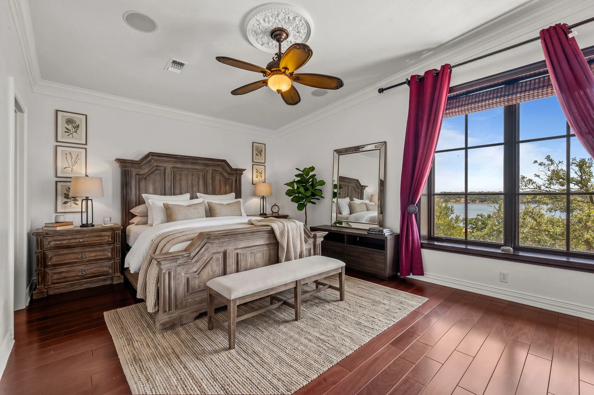 Hardwood flooring, crown molding, large window with outdoor scenery, recessed lighting, and a ceiling fan with ornate medallion-Staged
