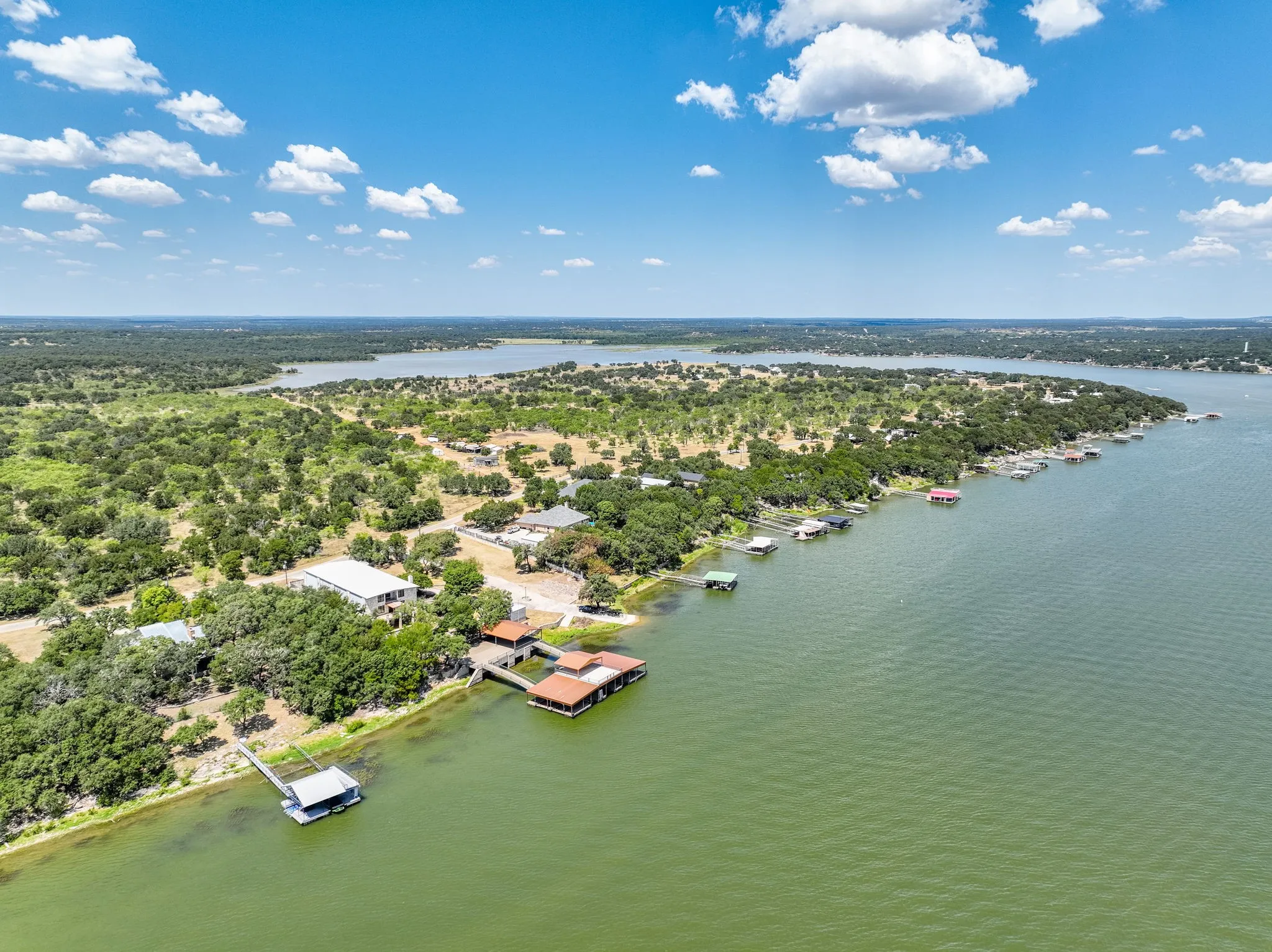 Expansive waterfront property featuring mature trees, multiple private docks, and direct water access