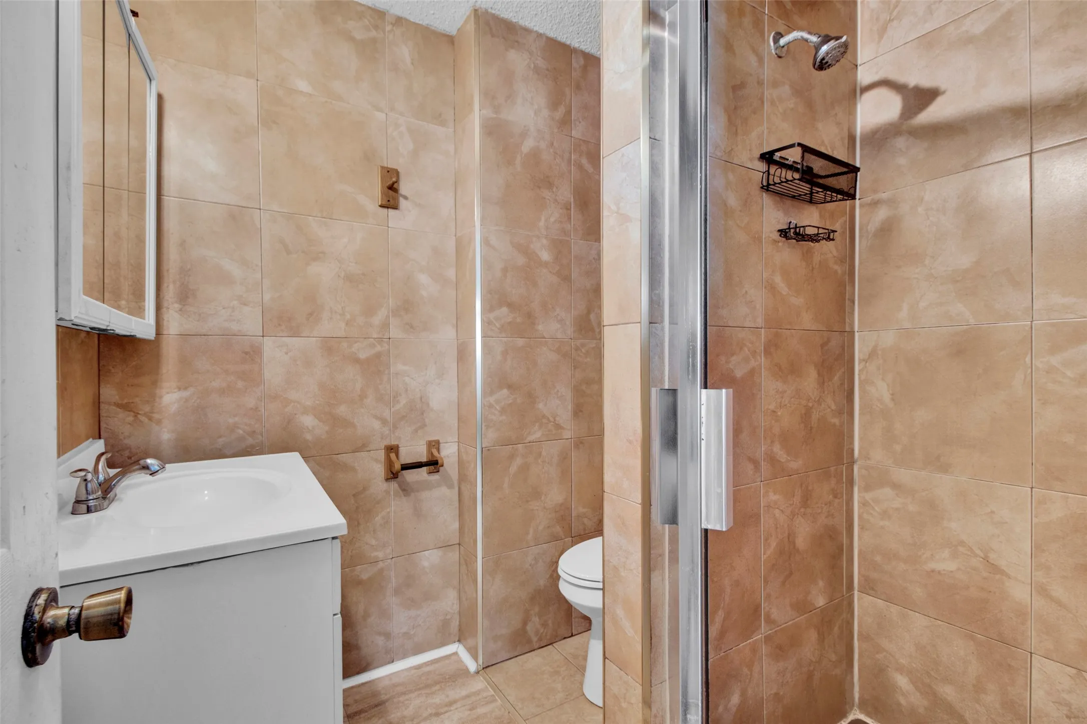 Vanity with integrated sink, chrome faucet, and mirrored medicine cabinet