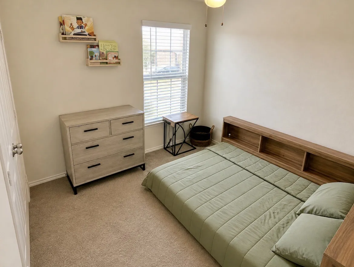 Carpeted flooring, window with blinds, ceiling fan, built-in shelving, and a closet with a white panel door