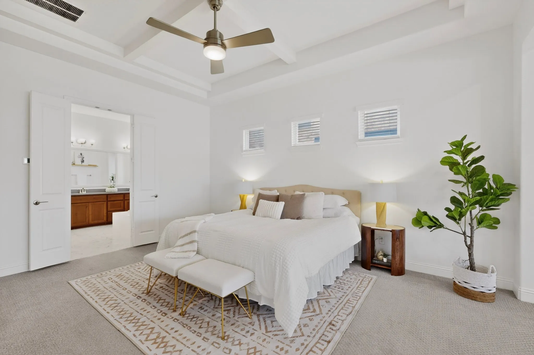 Recessed ceiling with a modern ceiling fan, two square windows with blinds, light-toned carpeting, and double doors opening to an adjoining room