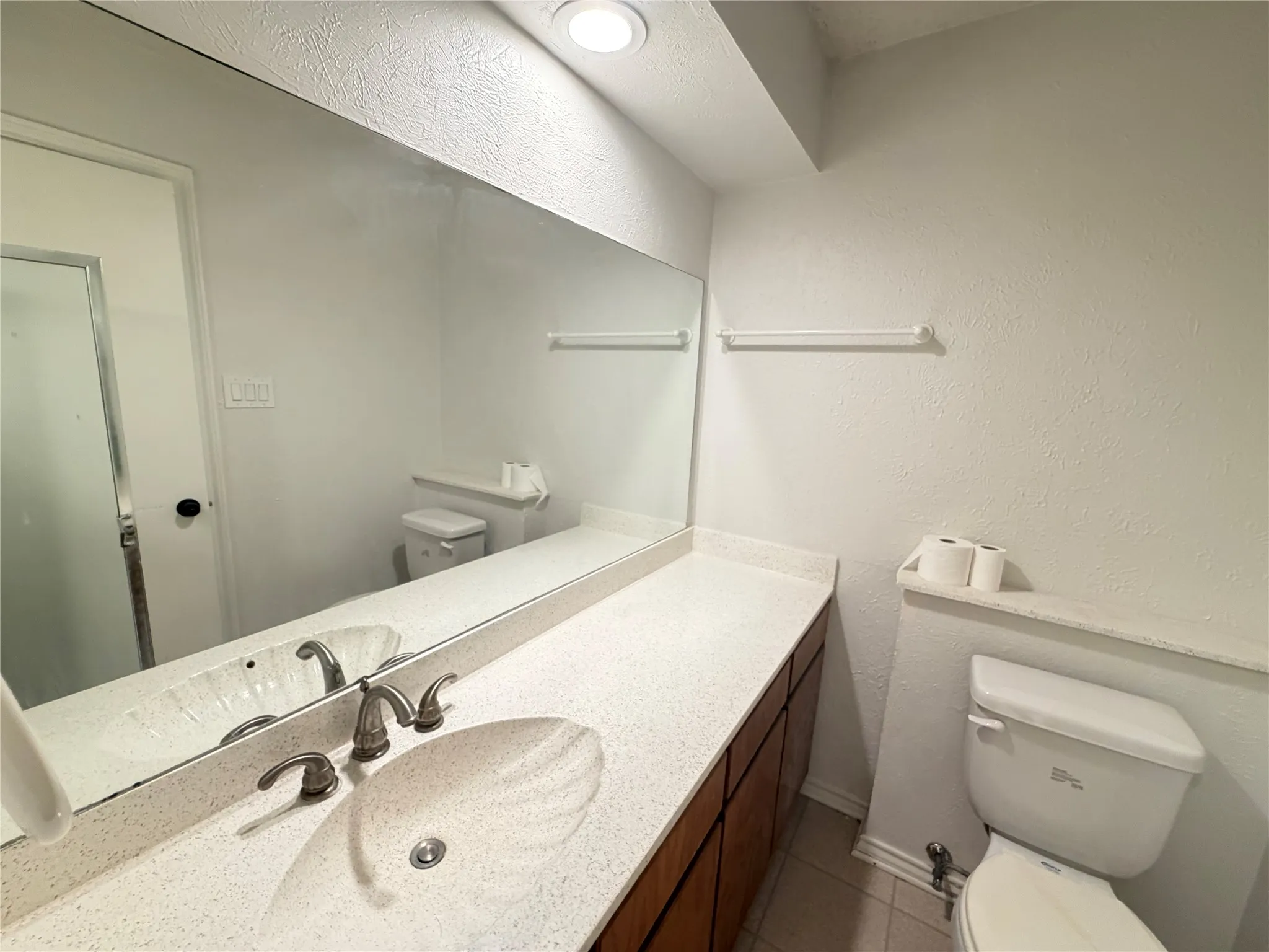Integrated vanity with an undermount sink, dual-handle faucet, and spacious countertop
