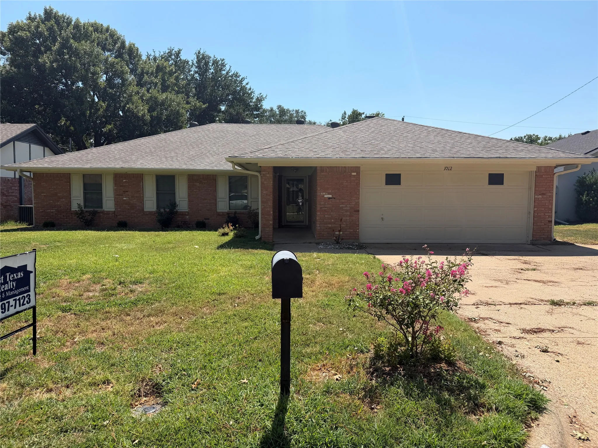 Brick exterior with a gabled roof and attached two-car garage