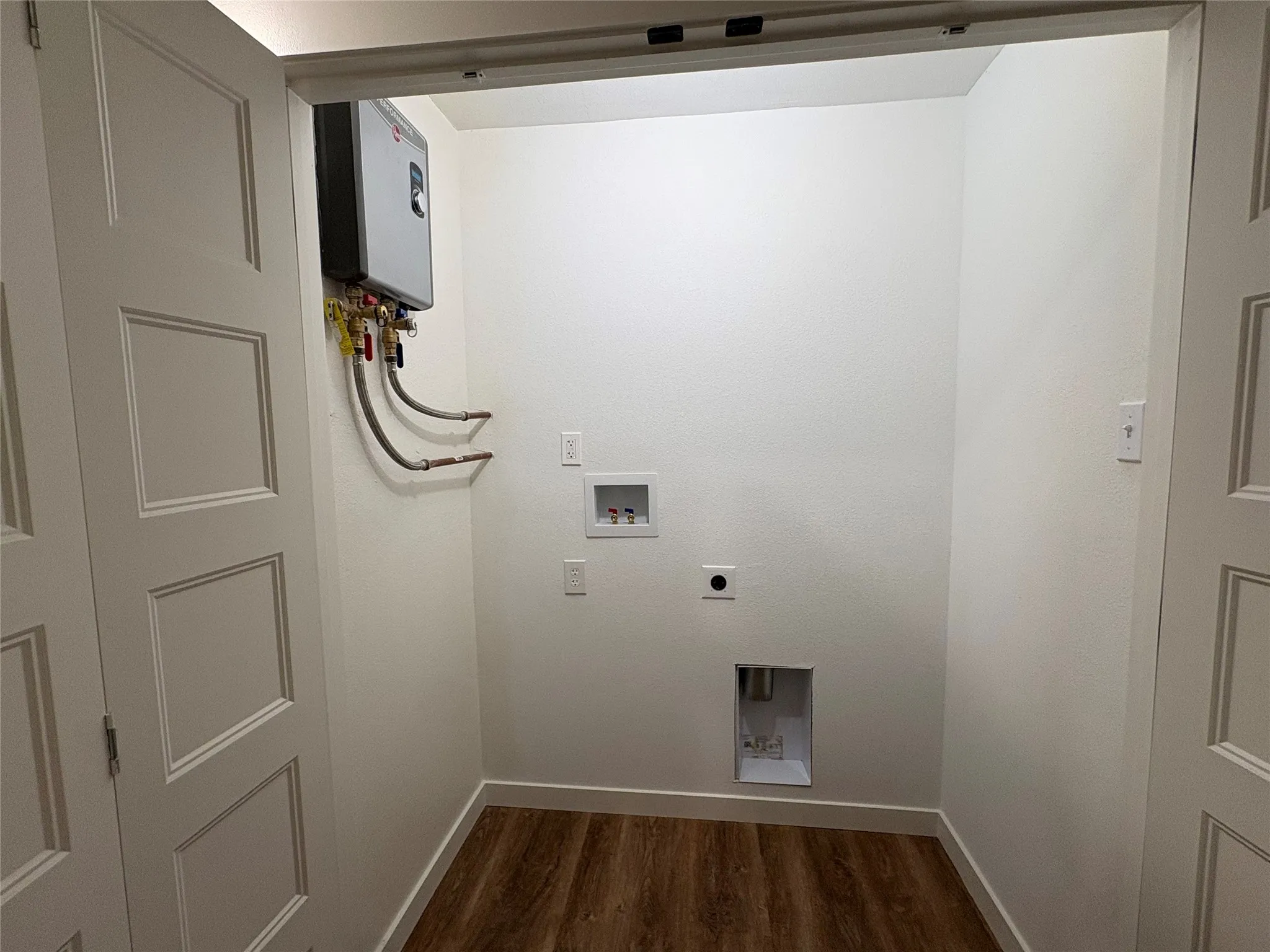Utility Closet wNew Tankless Water Heater, Full Size W/D  Hookups
