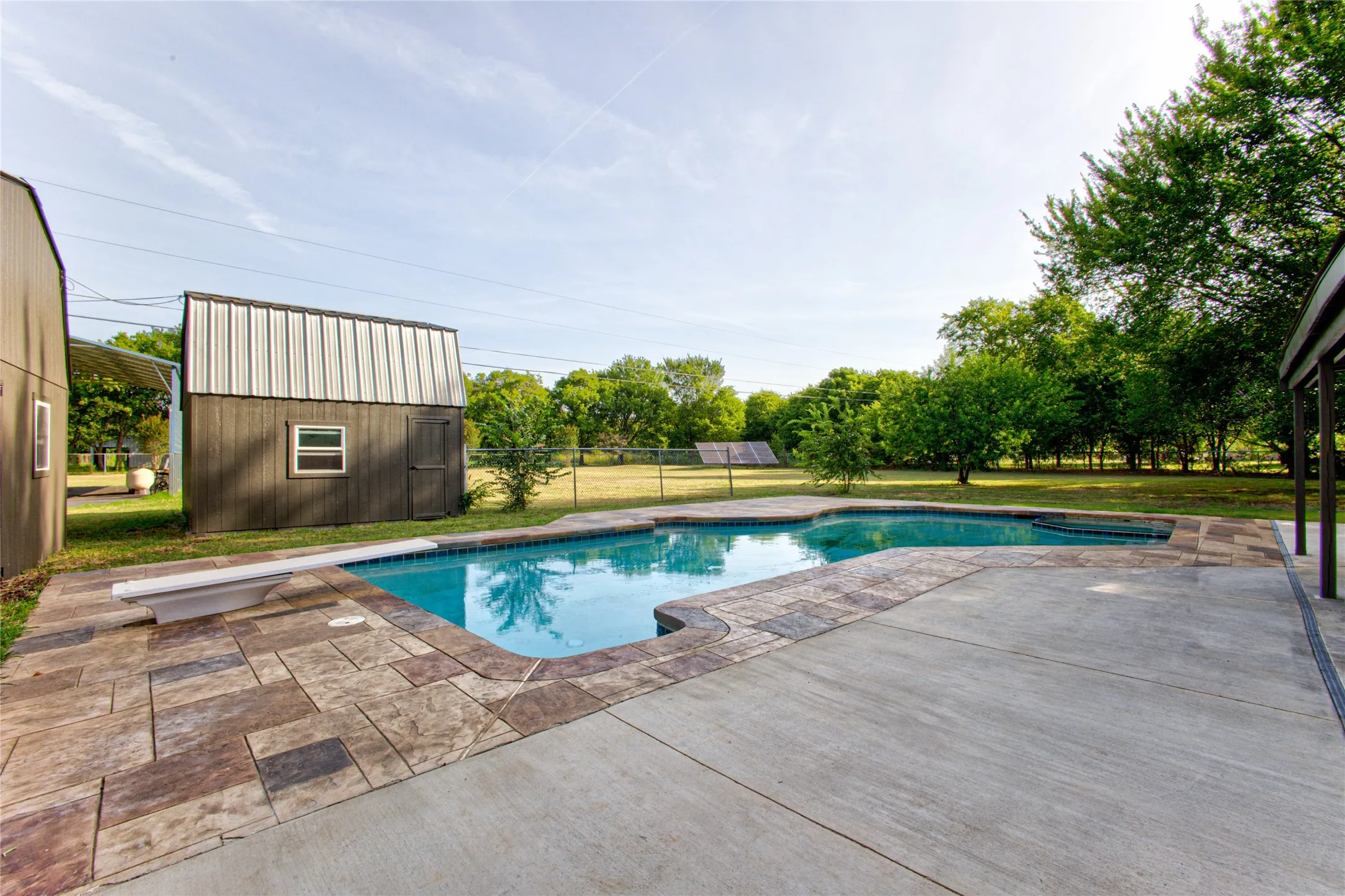 Outdoor swimming pool with integrated spa and diving board