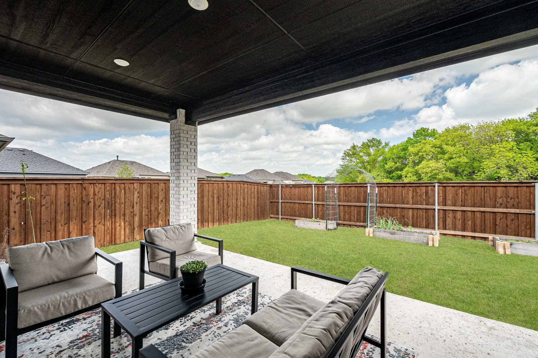 Fenced backyard with an outdoor living space and a patio