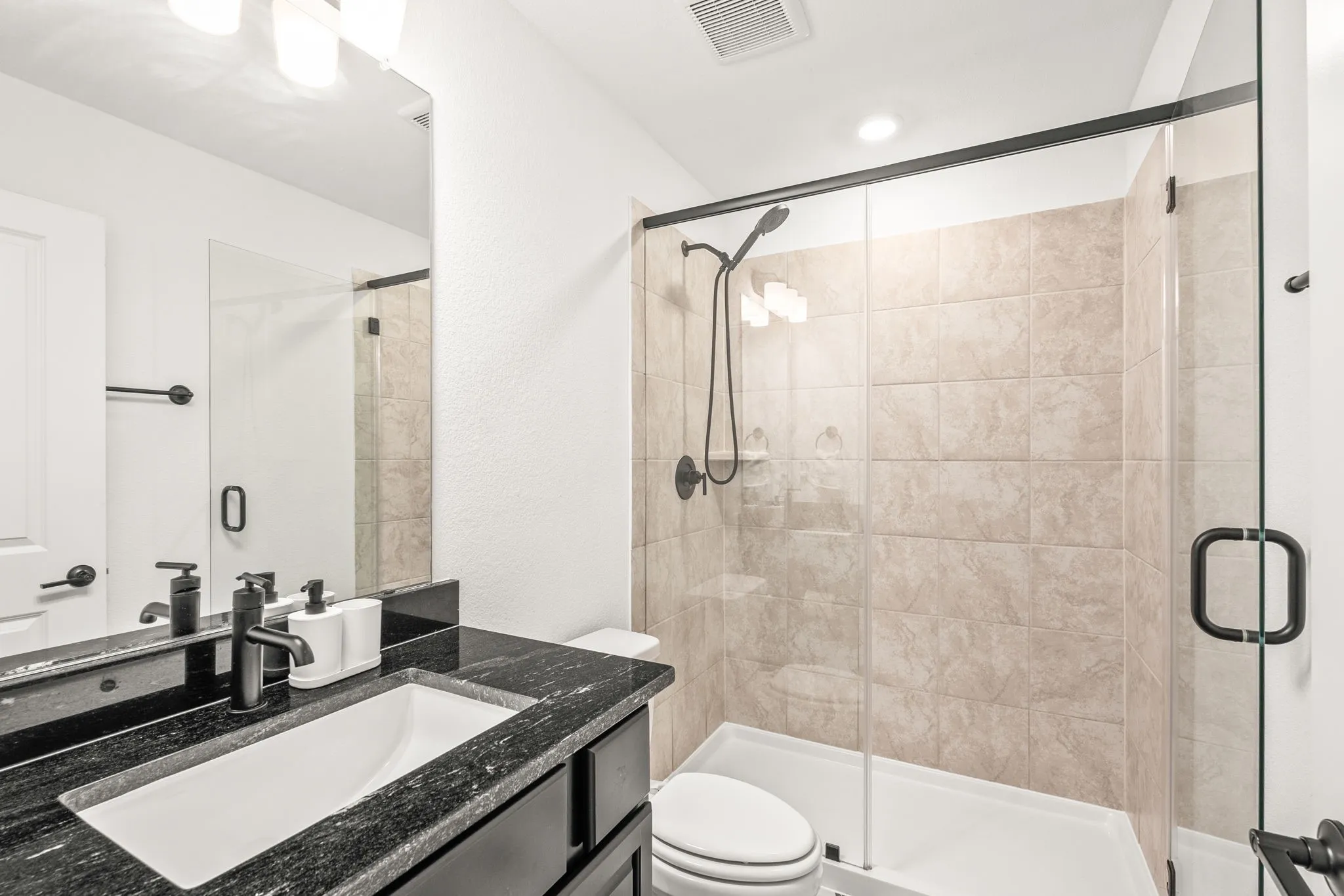 Full bathroom featuring vanity and a stall shower