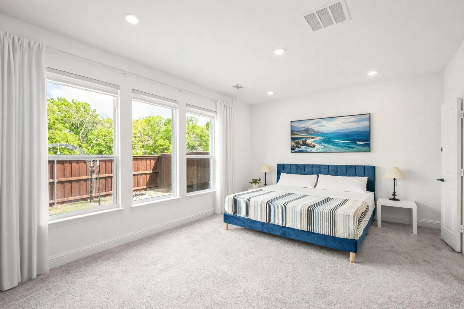 Bedroom with light colored carpet and recessed lighting
