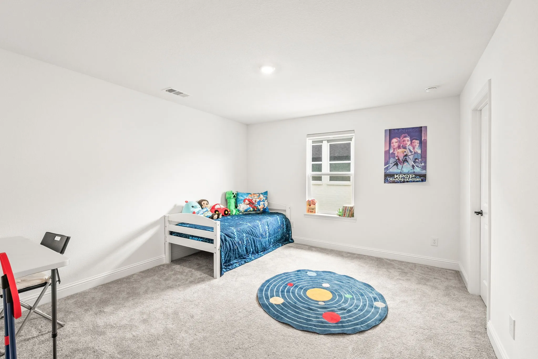Bedroom with light carpet and baseboards