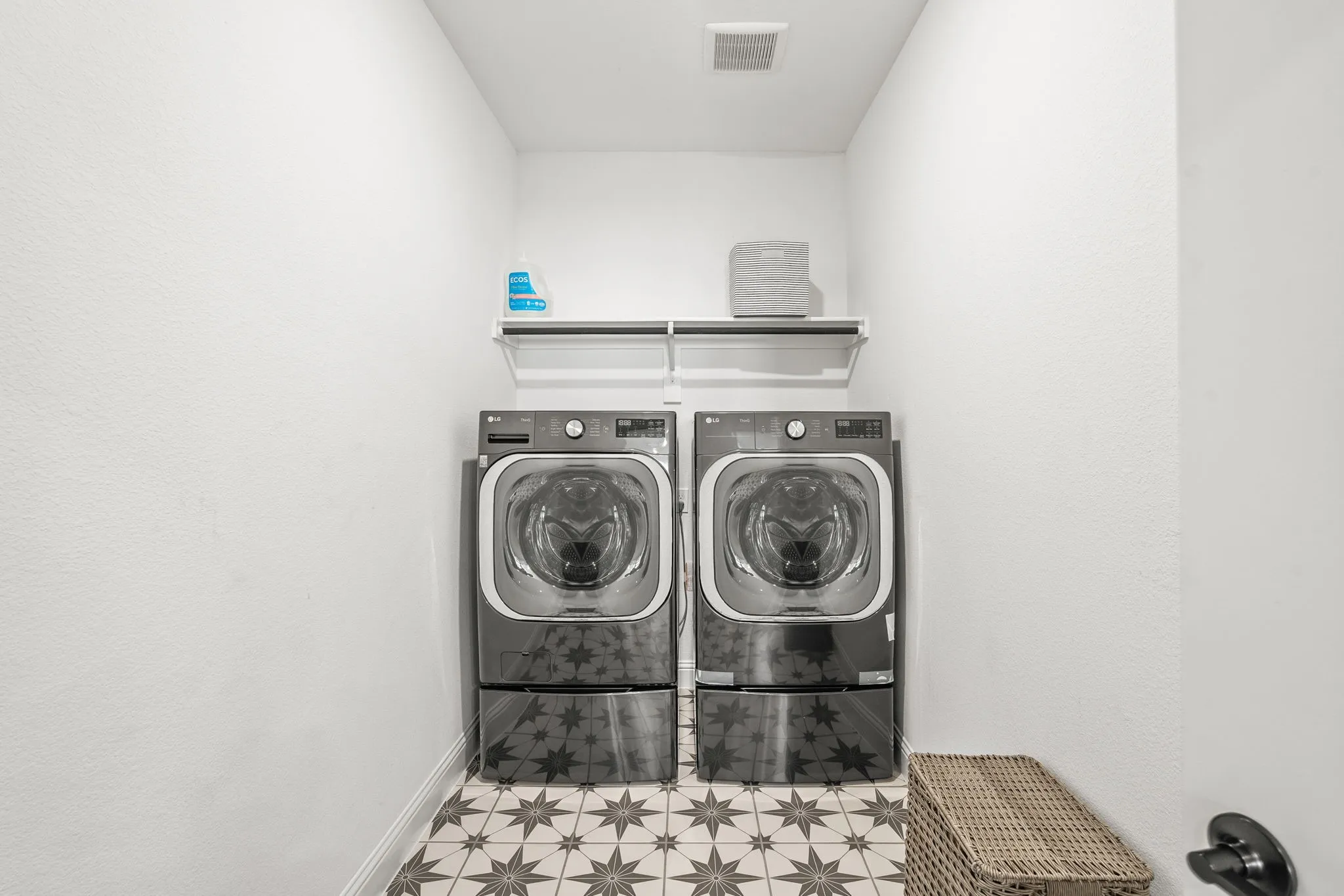Laundry area featuring washing machine and clothes dryer and baseboards