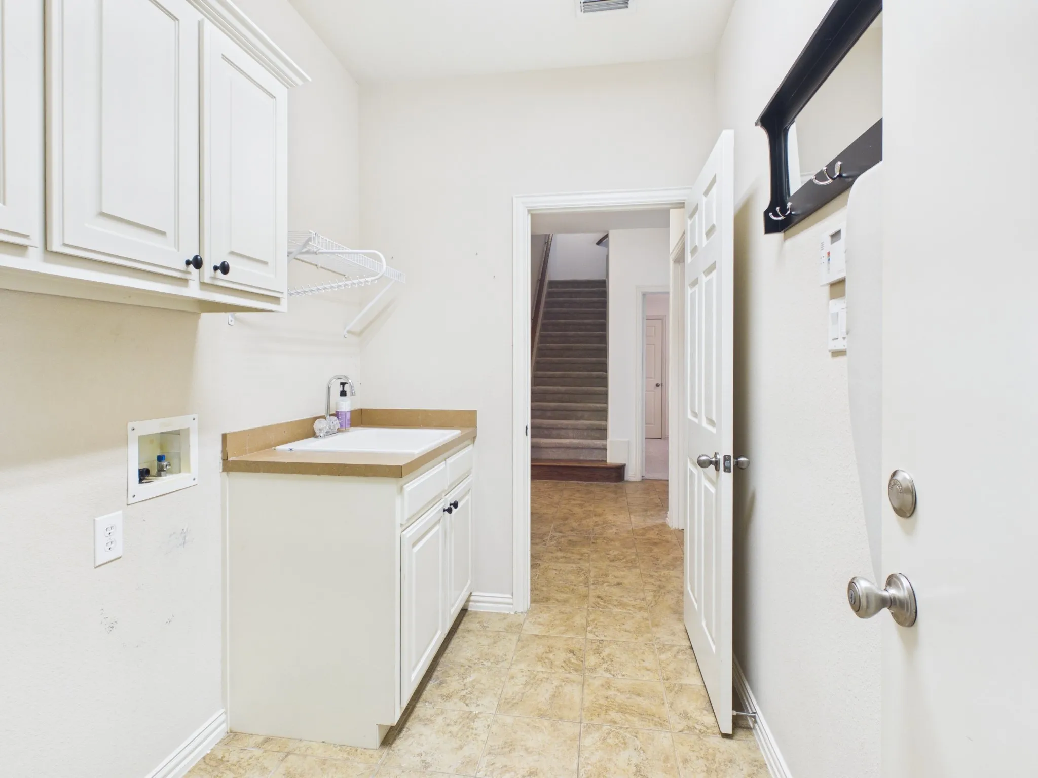 Spacious laundry space with sink
