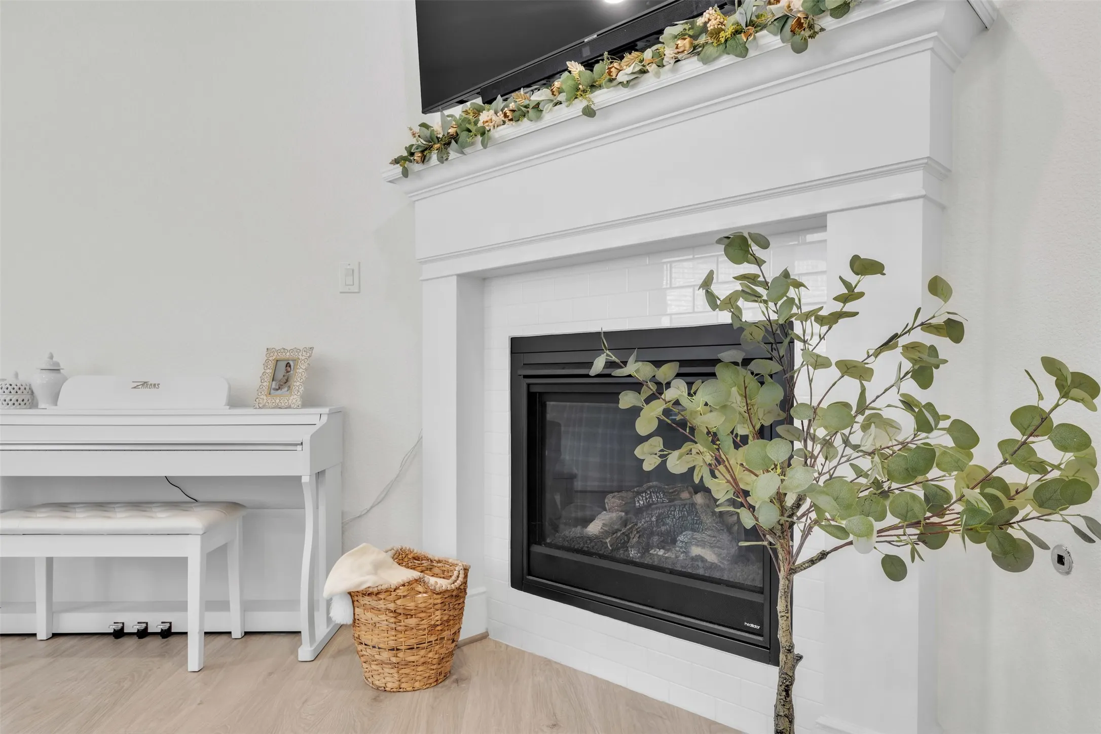 Fireplace with a white mantel and subway tile surround, featuring a black firebox