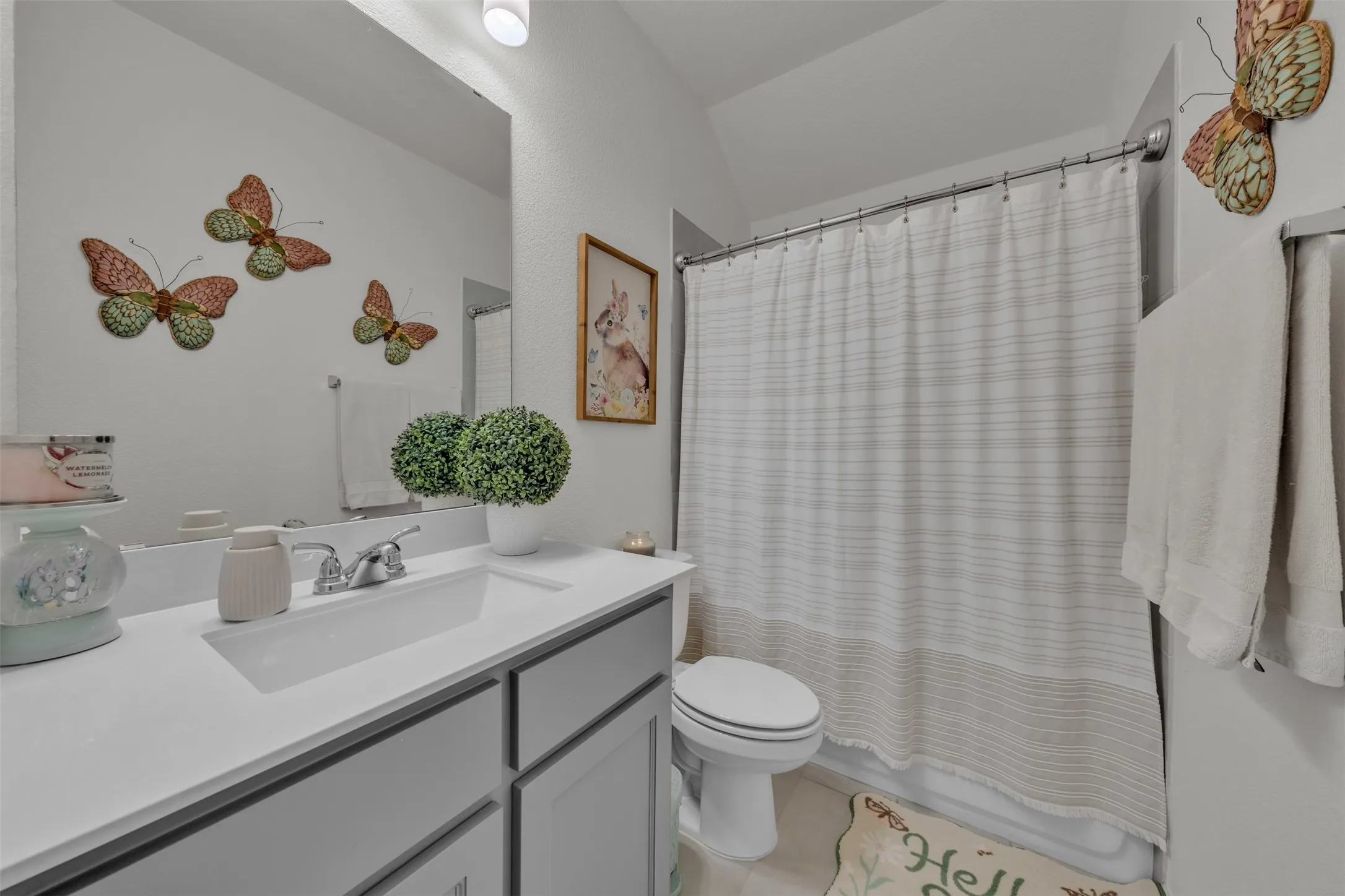 Vanity with an integrated sink, polished chrome faucet, and gray cabinetry