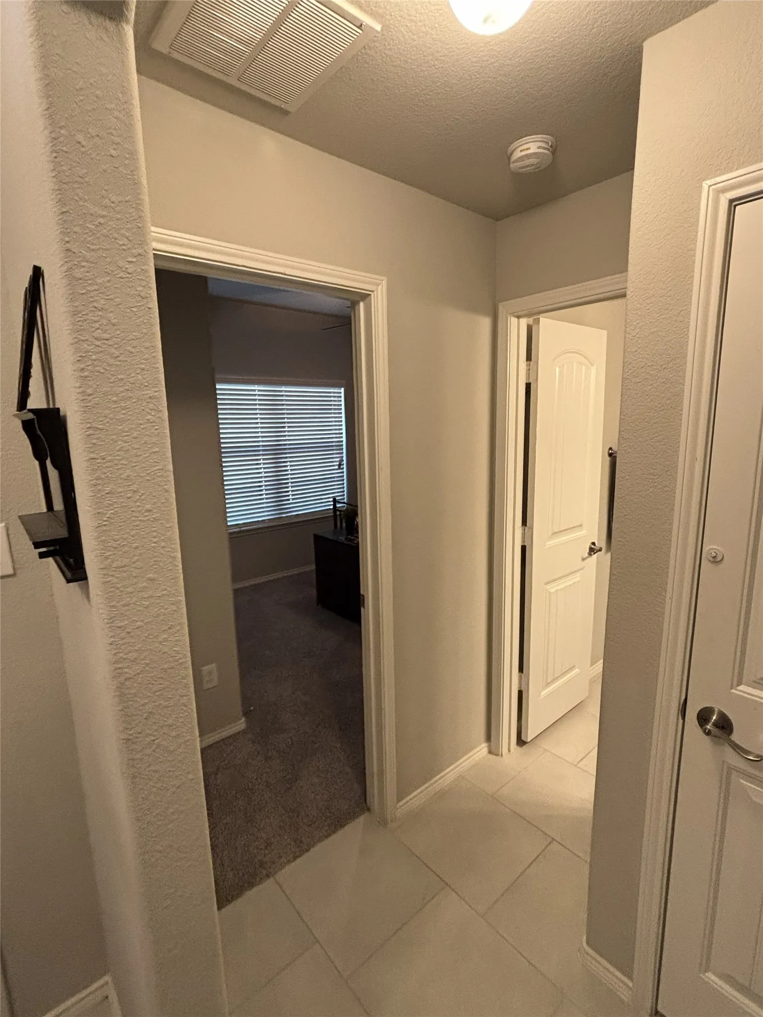 White tile flooring in the hallway