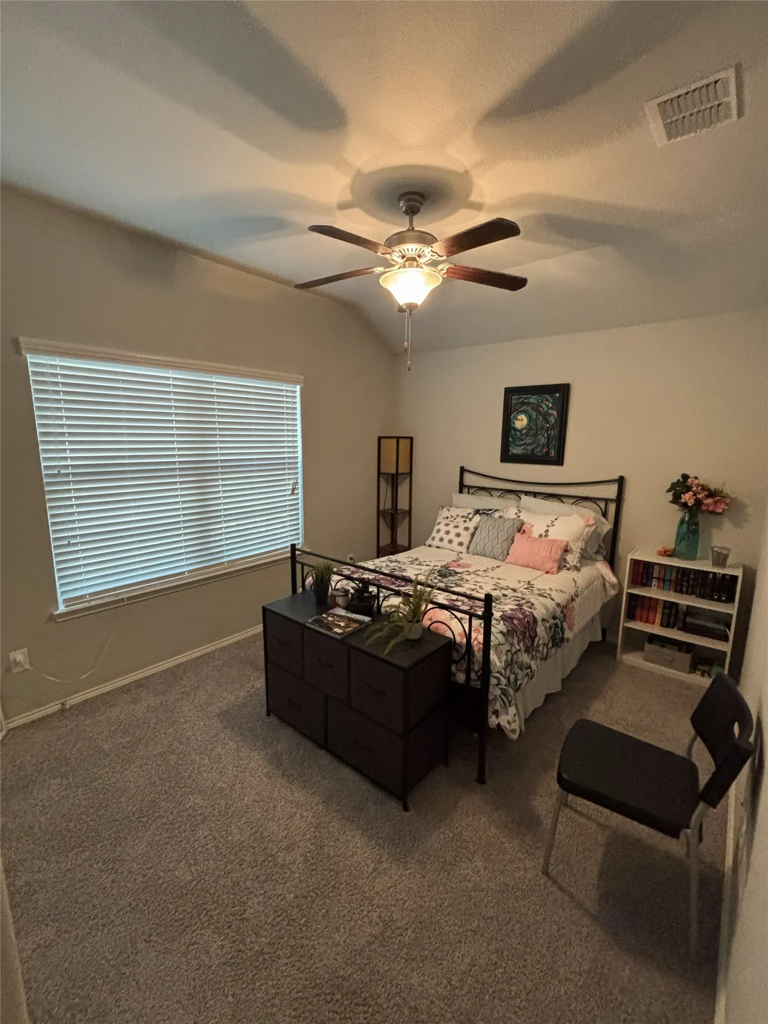 Vaulted ceiling, built-in ceiling fan with light fixture, carpeted flooring, window with blinds, and white painted walls