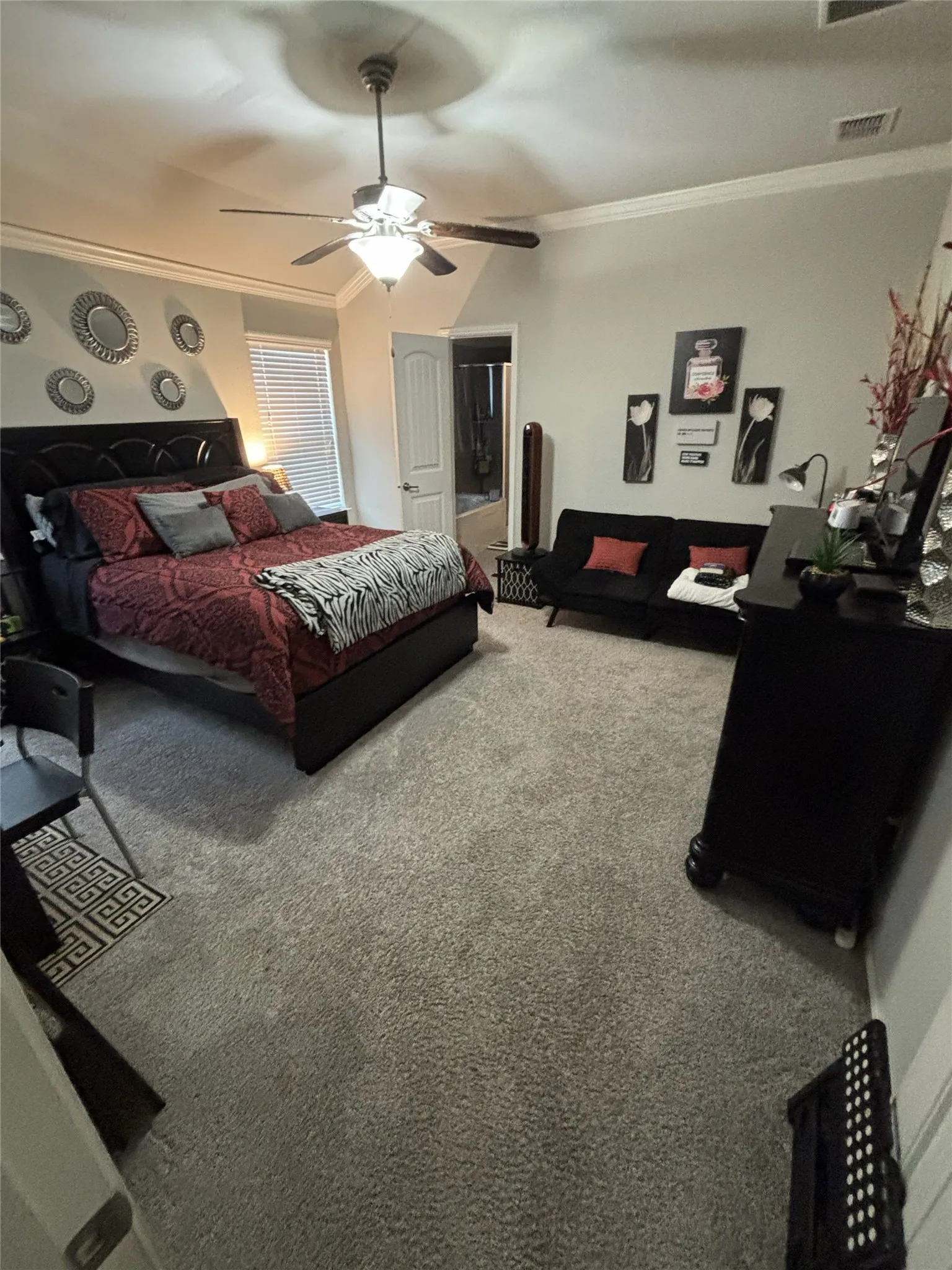 Recessed ceiling, crown molding, ceiling fan with integrated lighting, carpeted flooring, and window with blinds