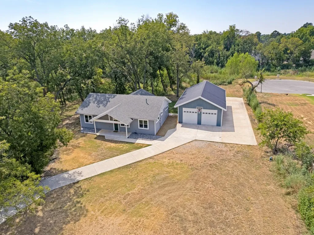 Welcome home to peaceful country living within the city limits of Denison. Home also features a detached garage/workshop is 30’x40’ climate controlled with HVAC and spray foam insulation and two doors. Long concrete driveway with 90” x 20” pad on side, perfect for parking recreational vehicles.