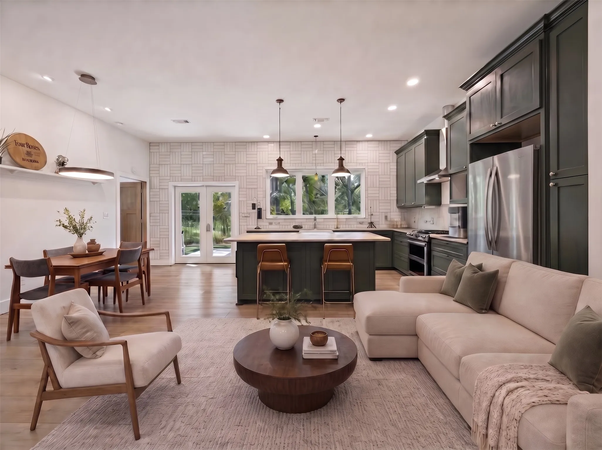 Open-concept living space with wood-finish flooring, recessed lighting, and a white ceiling