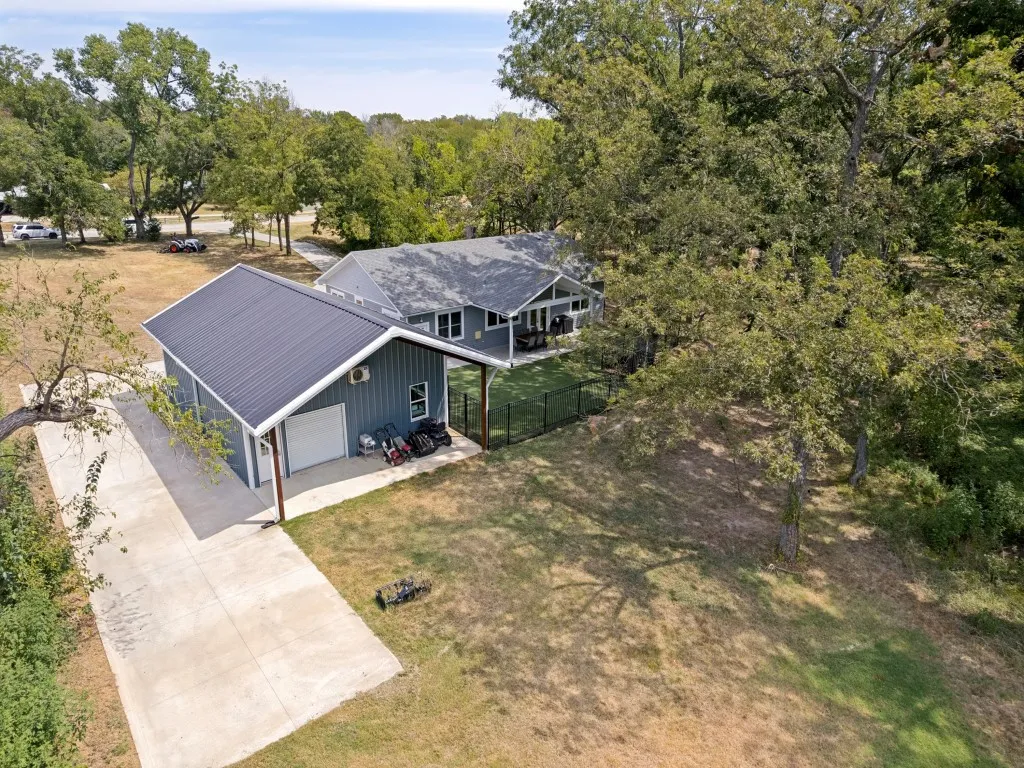 Detached outbuilding with metal roof and attached carport