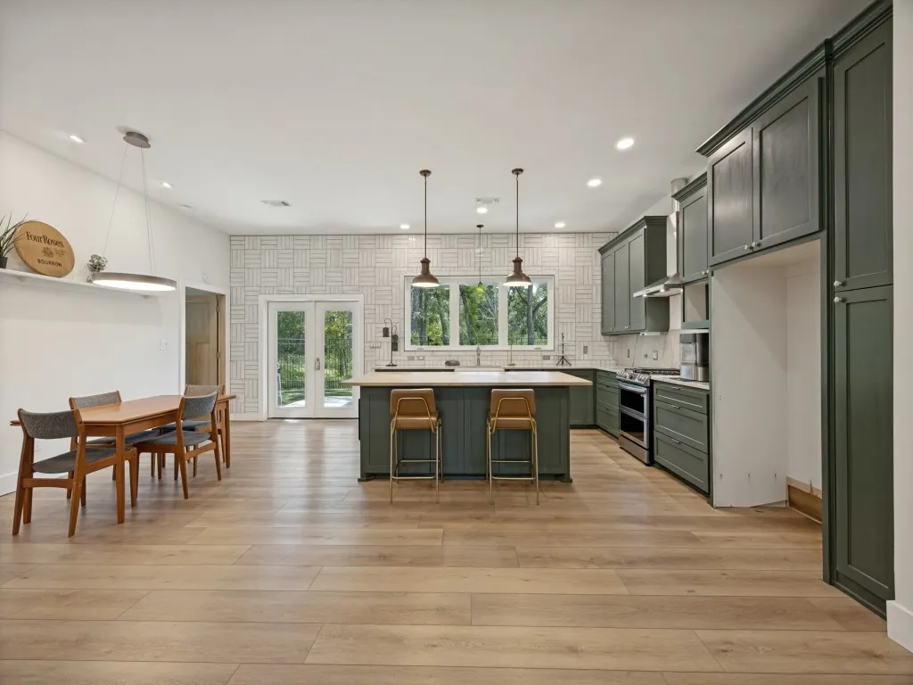 Open-concept kitchen and dining area featuring wood-finish flooring