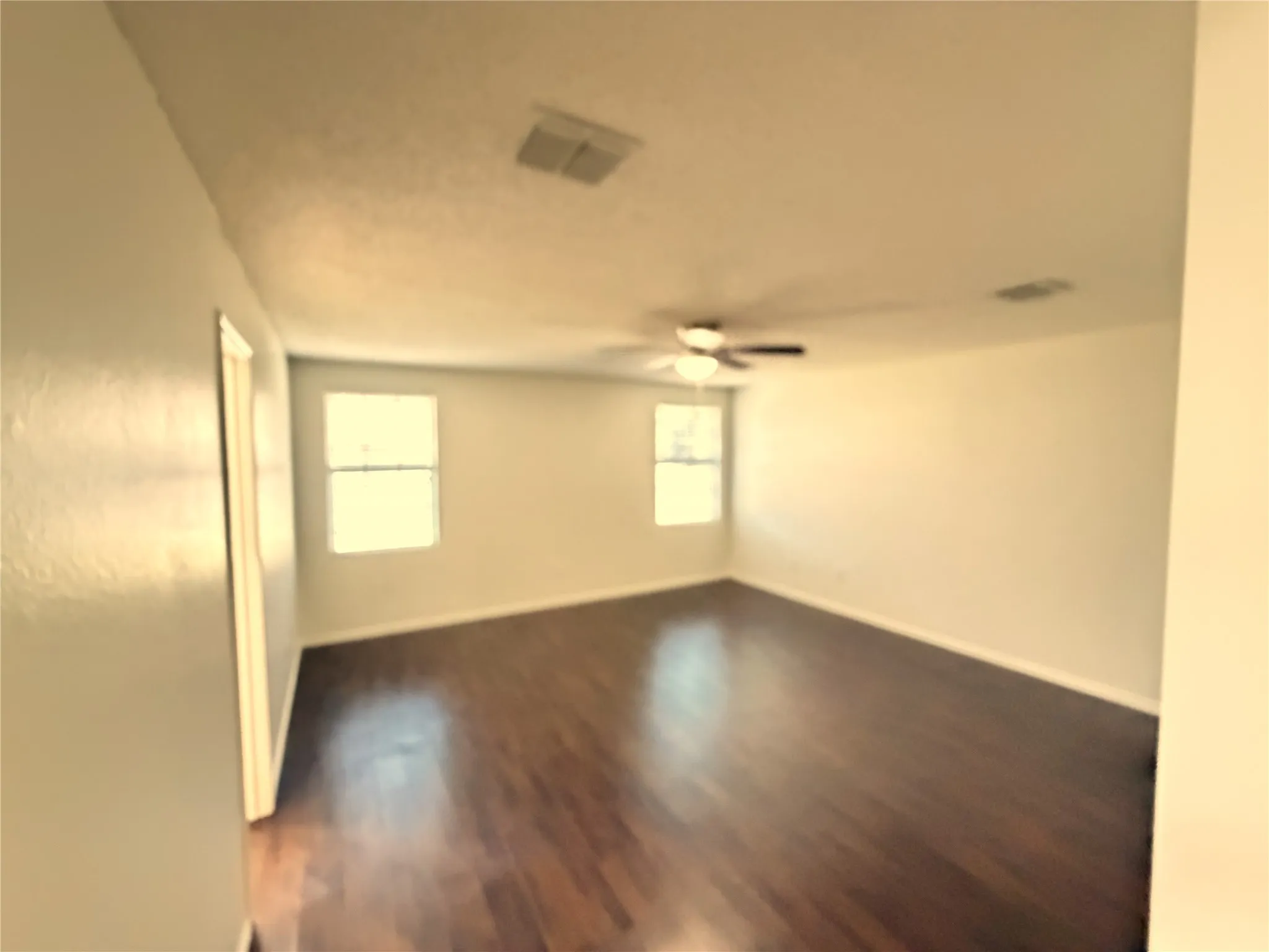 Recessed lighting, wood-finish flooring, and a ceiling fan