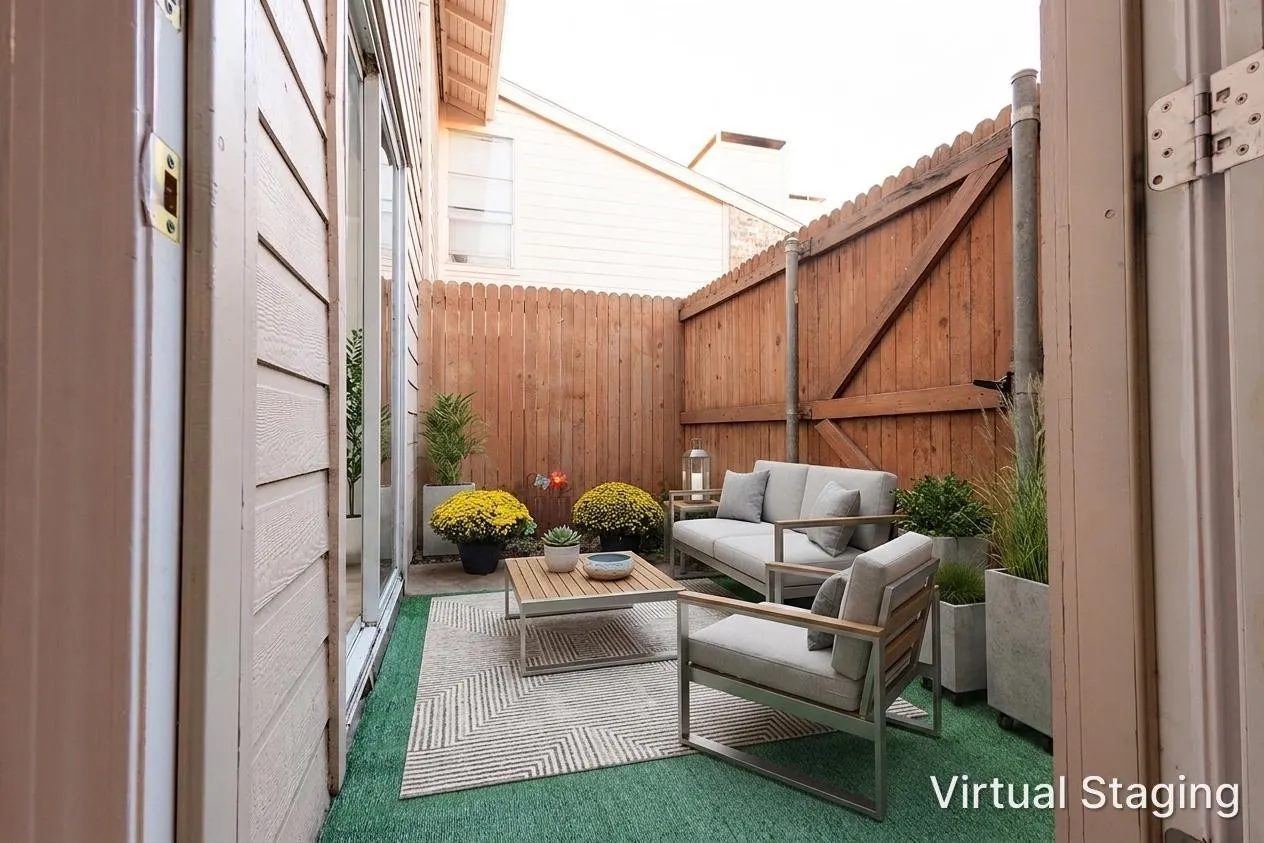 Private outdoor patio featuring a wood fence, artificial turf, and a sliding glass door