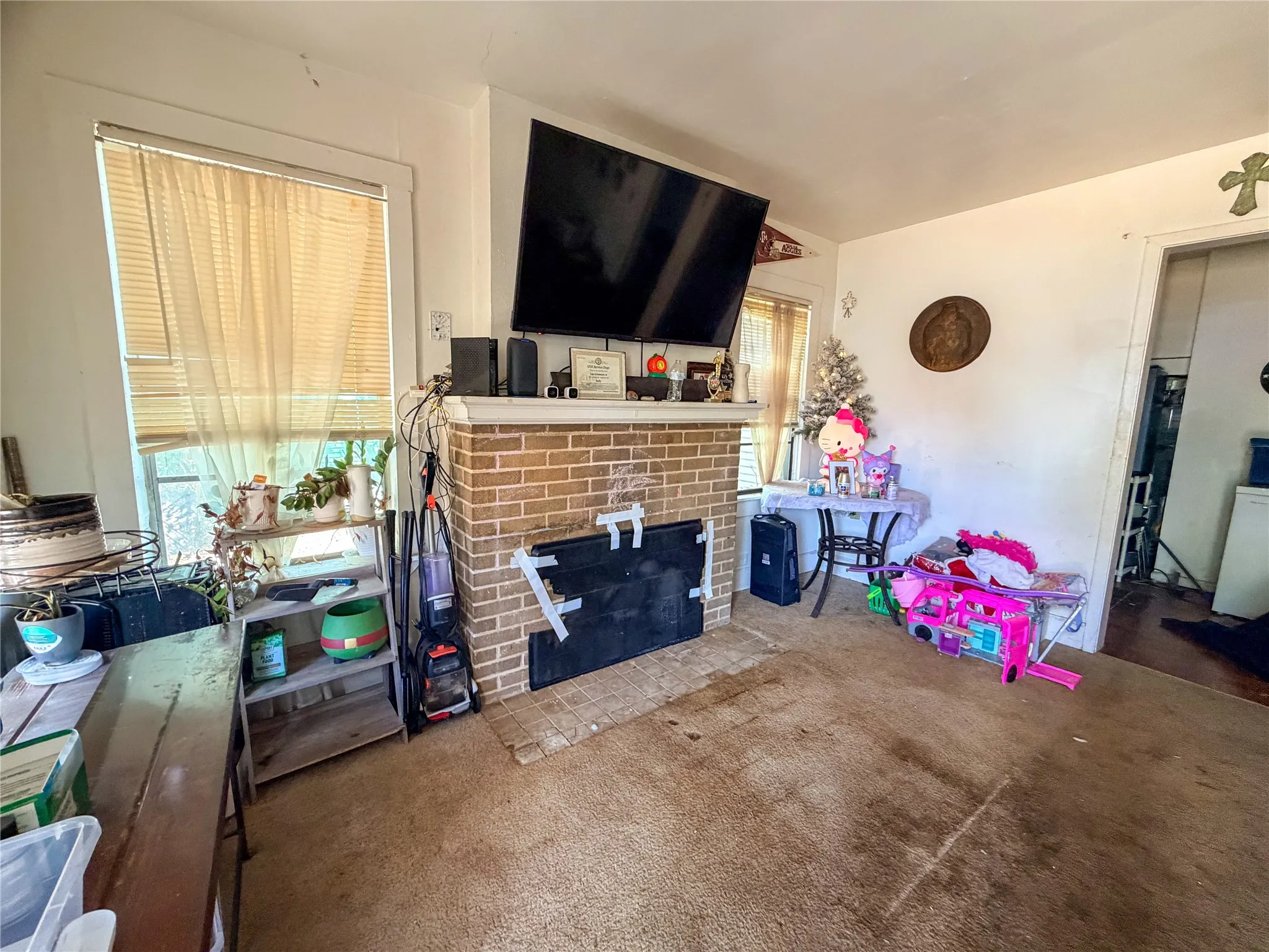 Brick fireplace with a mounted television