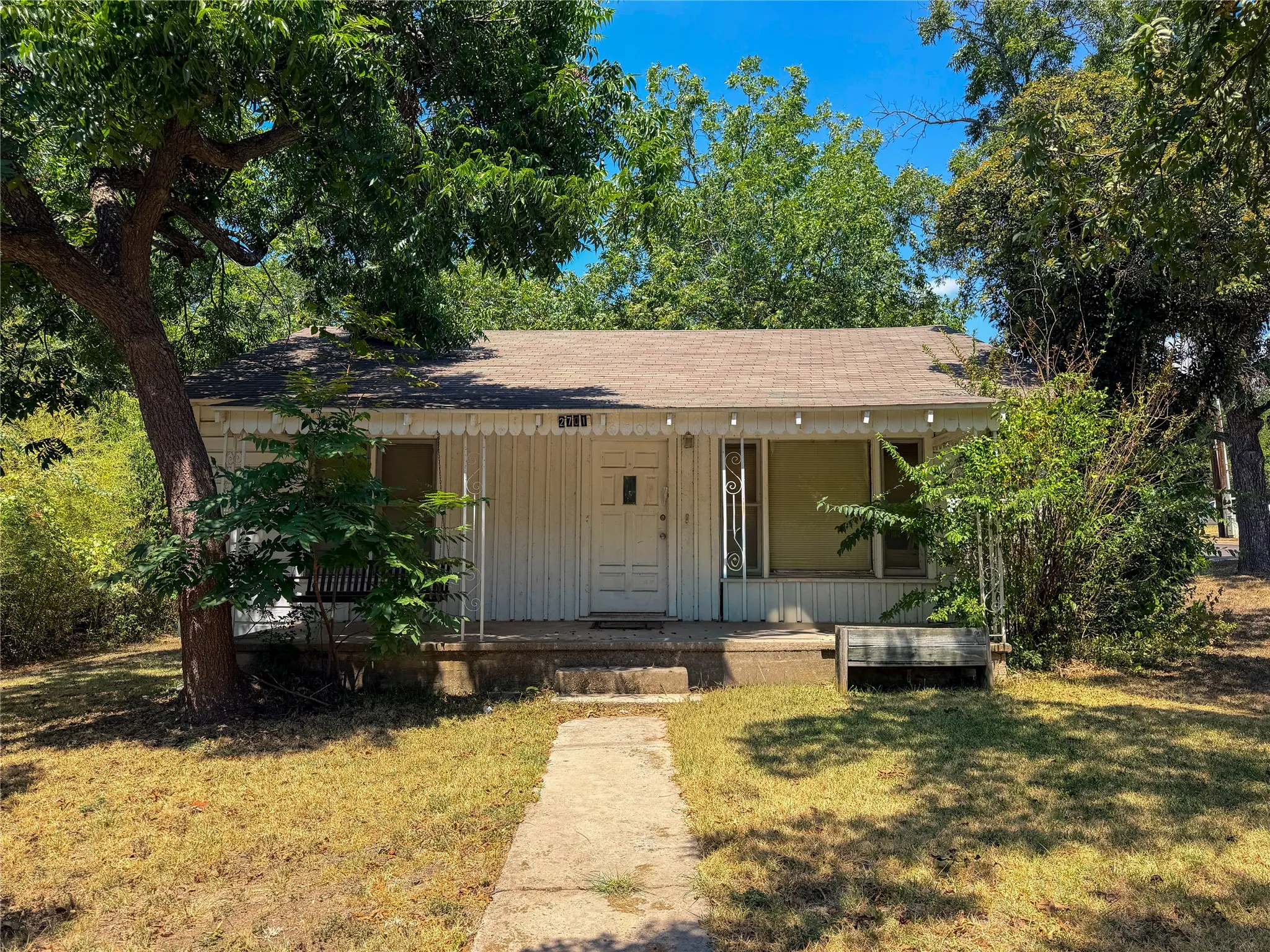 Front facade with white siding and a covered porch