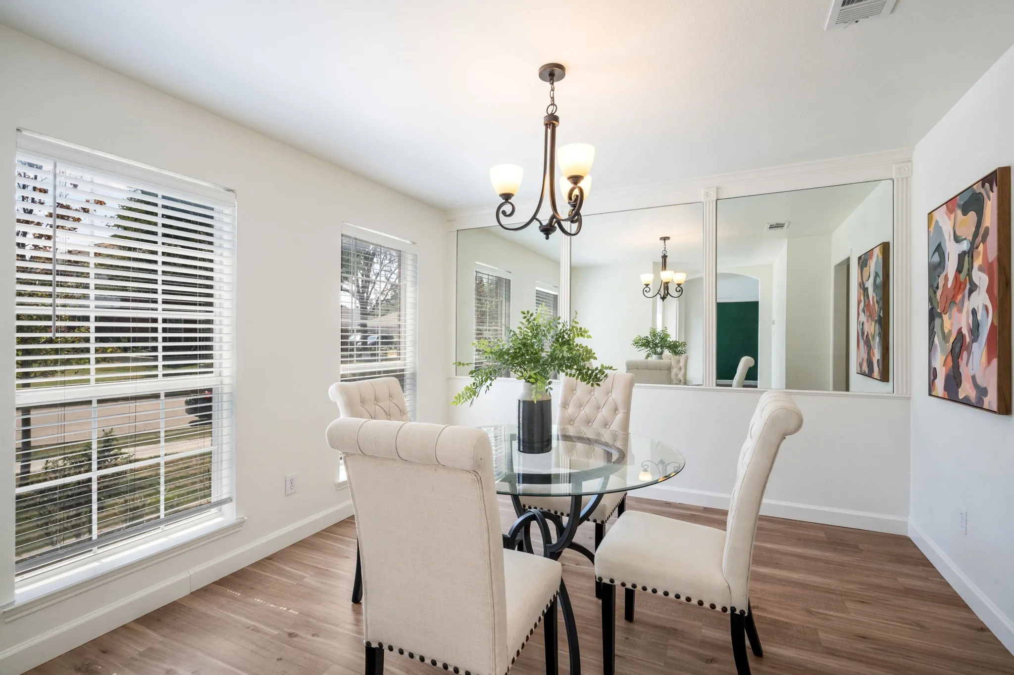 Recessed lighting, wood-finish flooring, multiple windows, & decorative chandelier.
