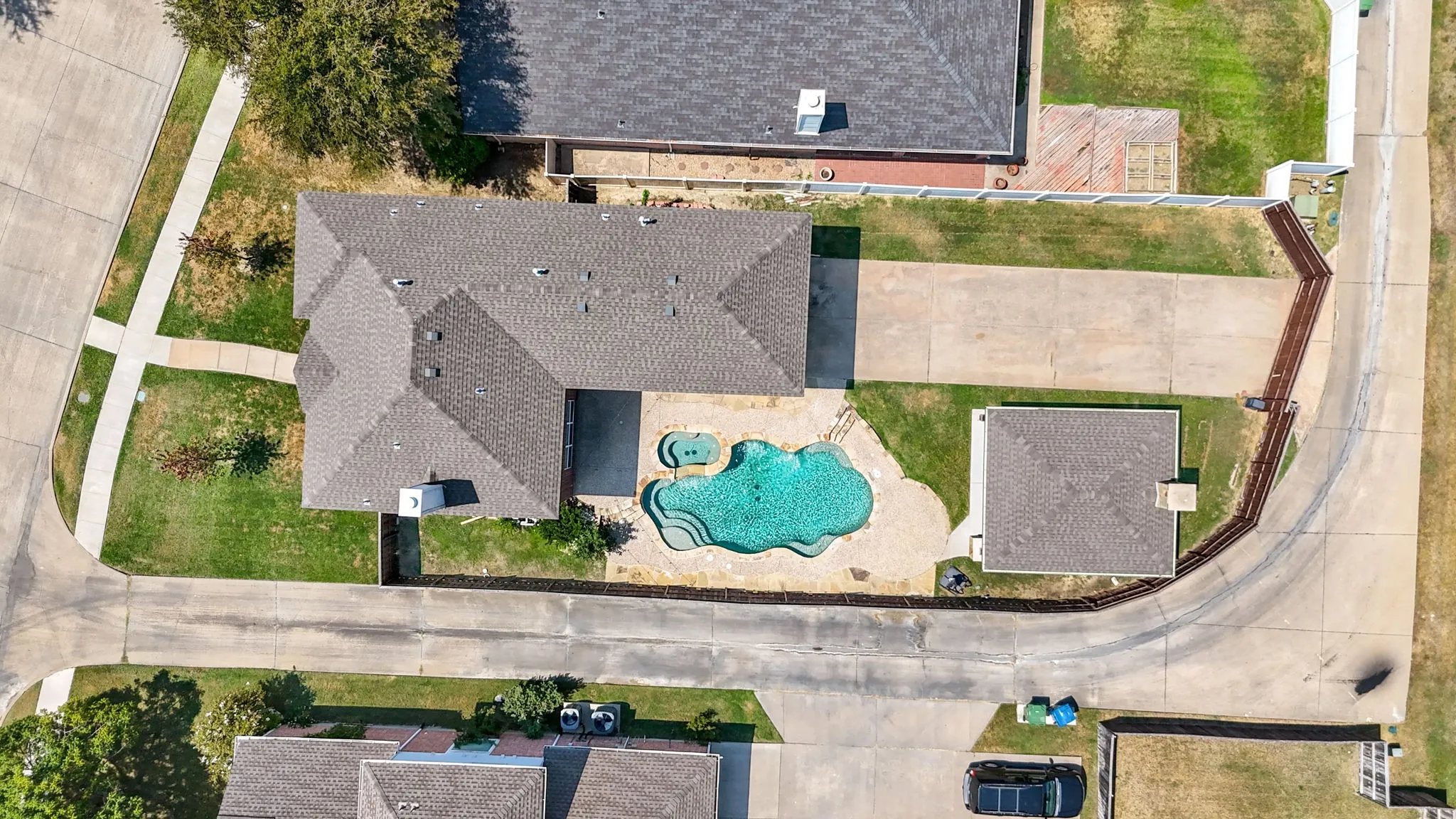 Spacious property featuring a large swimming pool, integrated spa, extensive concrete patio, and outdoor kitchen under the Pergola
