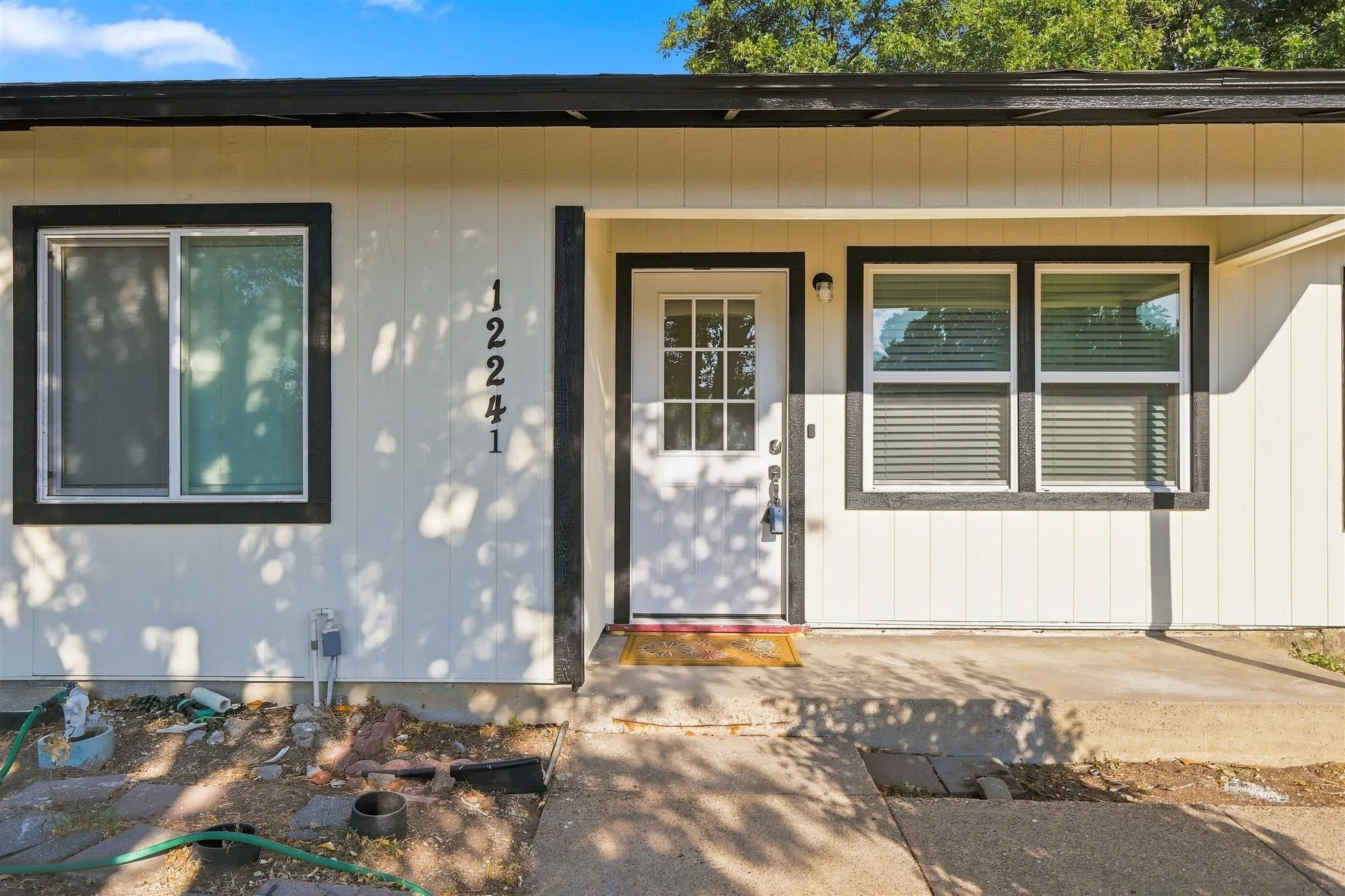 White vertical siding exterior with contrasting dark trim