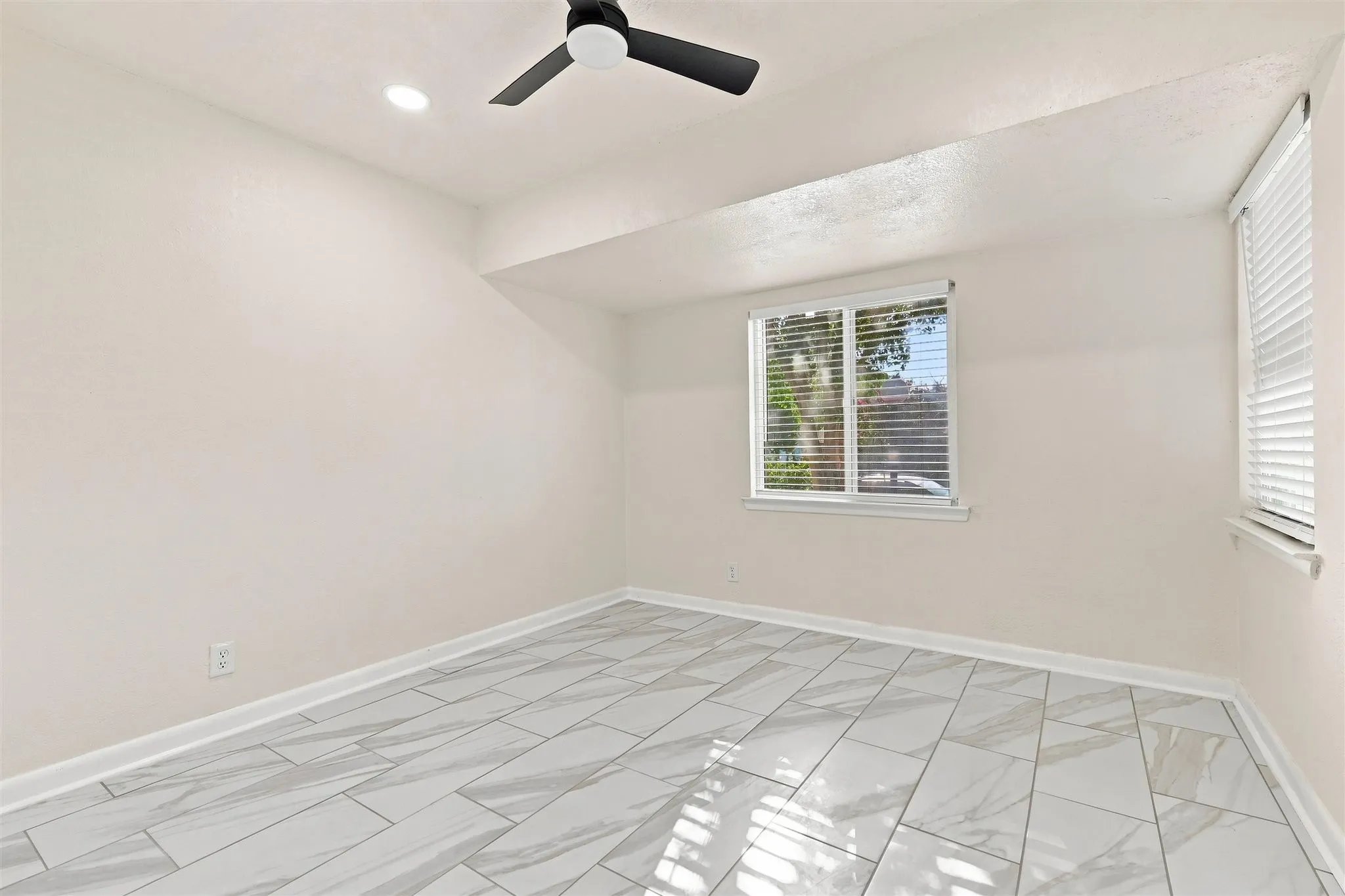 Recessed lighting, ceiling fan, window with blinds, and white tile flooring