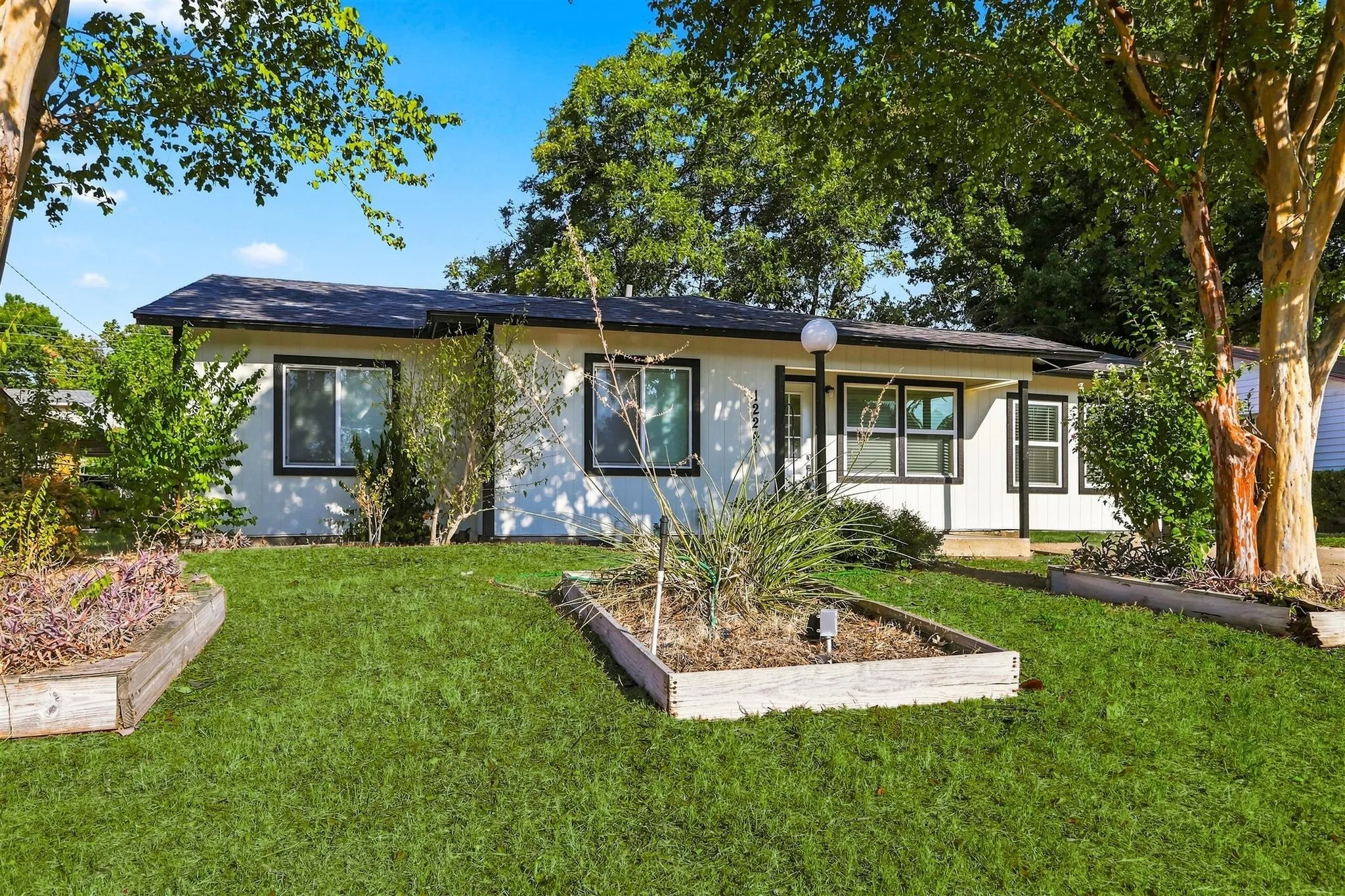 White exterior siding with black trim windows