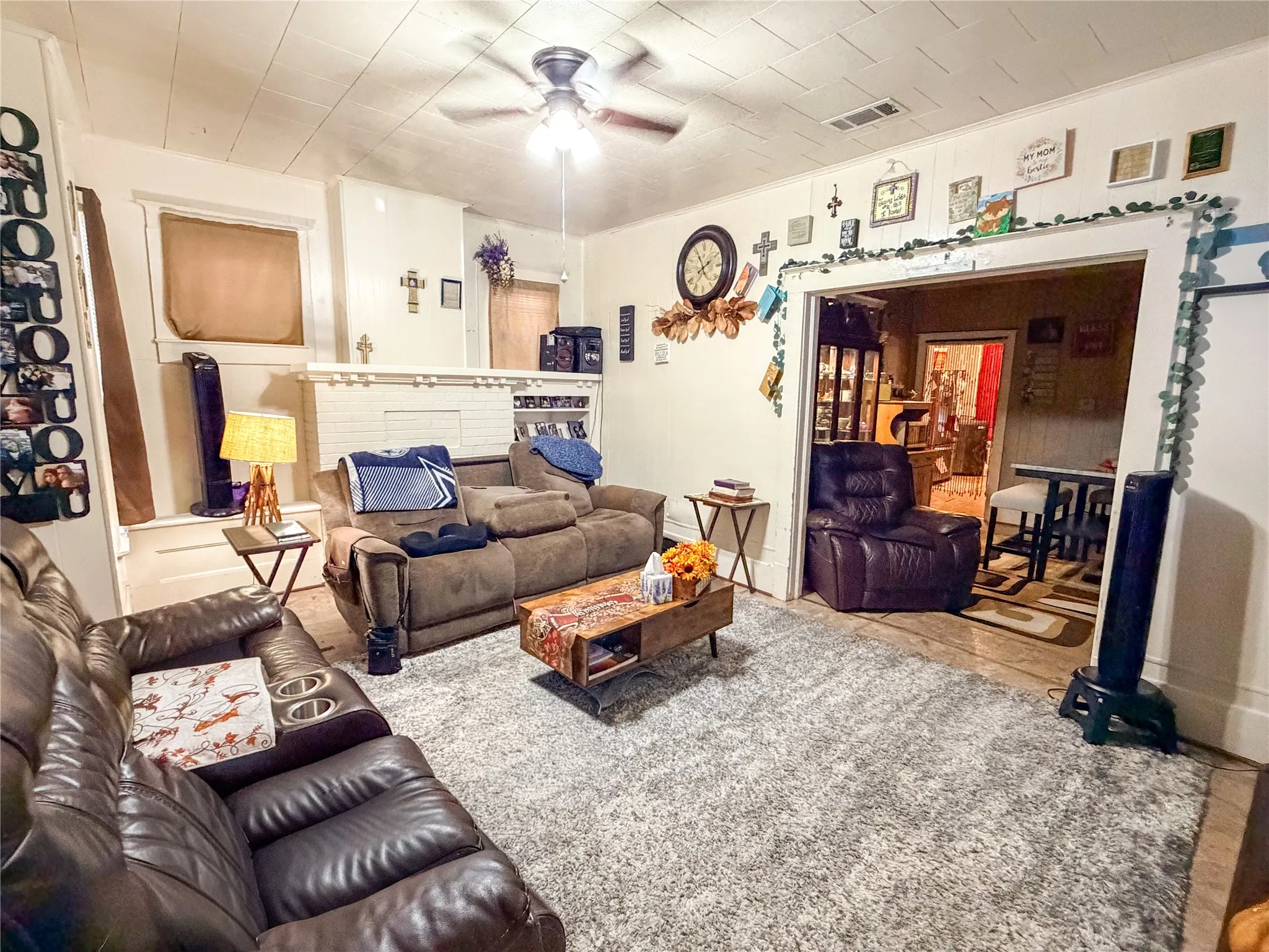 Recessed ceiling with an overhead fan light fixture, white painted walls, and a wide doorway opening