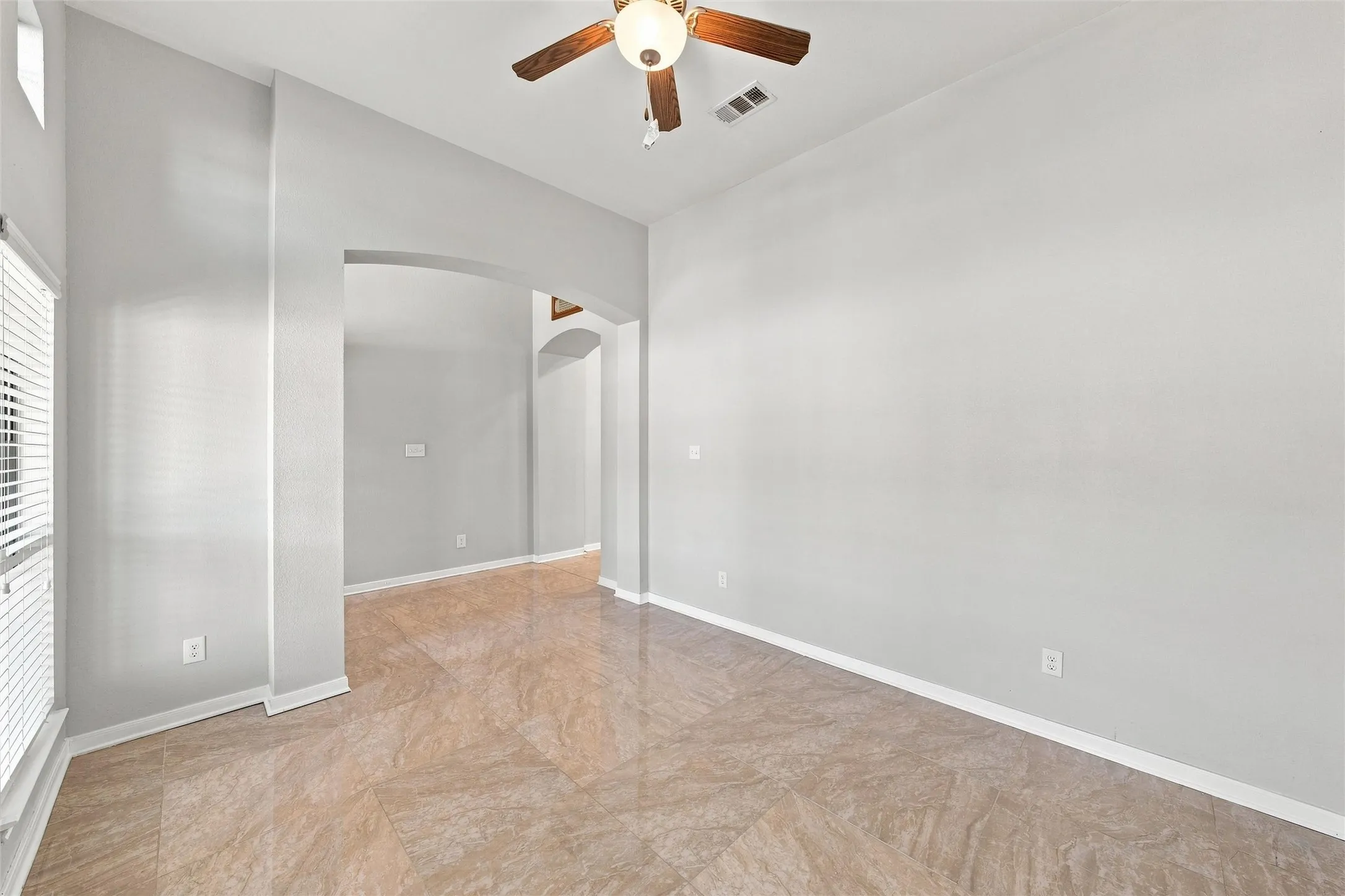 Soaring ceiling and clerestory windows bring in abundant natural light in this versatile space, ready for a second living area, formal dining, game room, or home office.