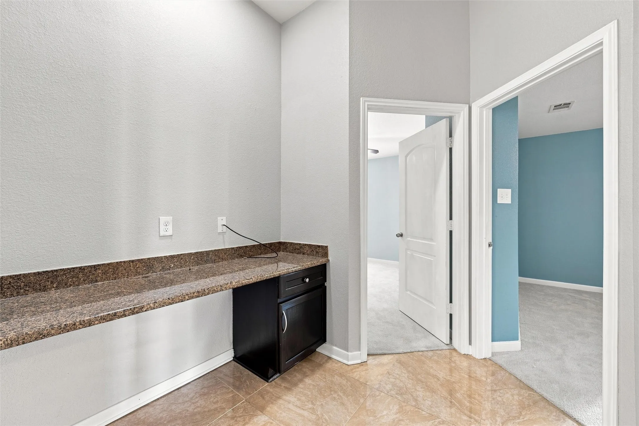 A built-in desk and counter space offers a convenient spot for a home workstation.