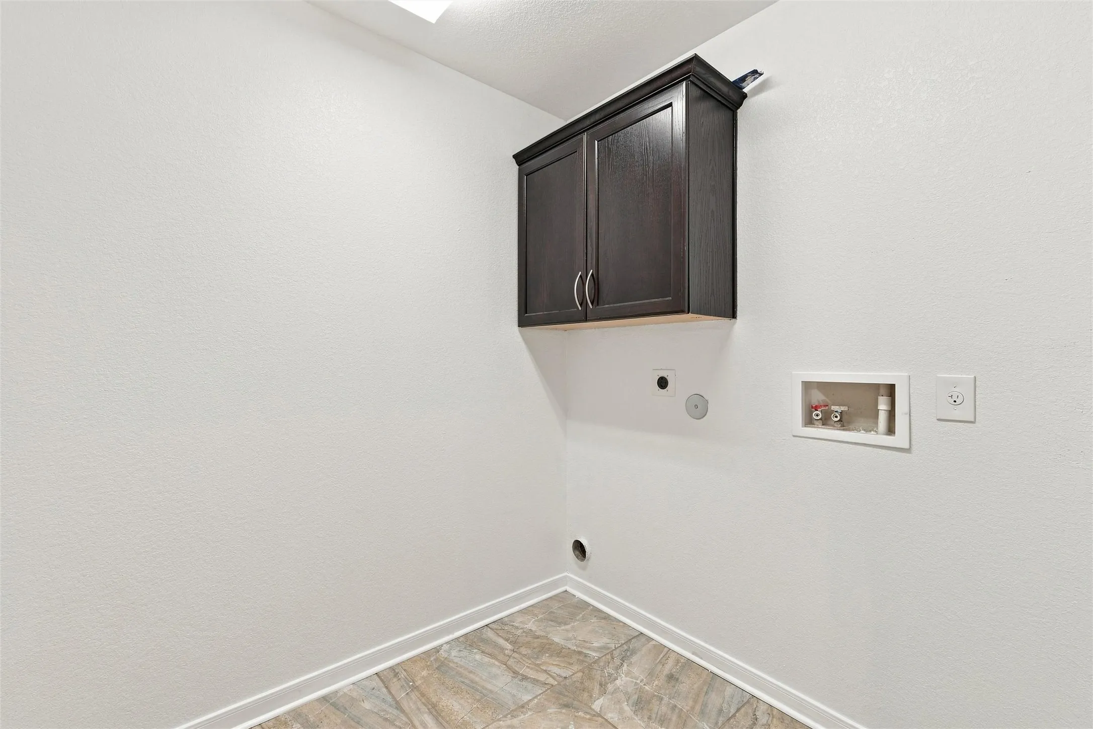 Utility room featuring dark cabinetry with dual handles, wood-finish flooring, neutral wall finishes, and recessed ceiling lighting