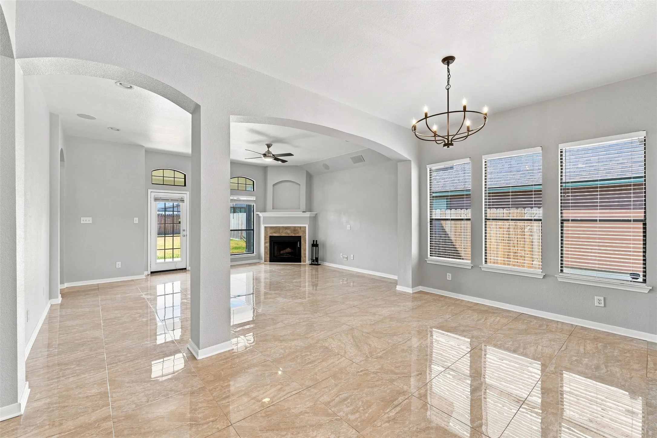 A peek toward the foyer highlights the open flow between the kitchen, entry, and living spaces.