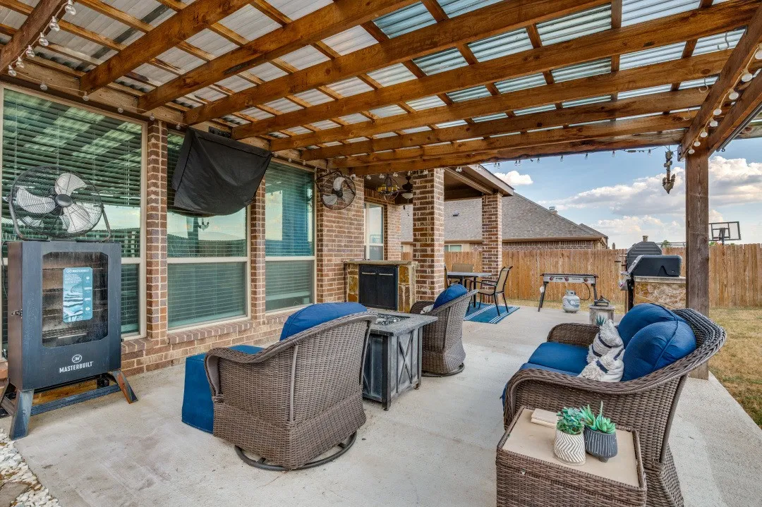 Covered living area outside- charcoal and gas grill staying